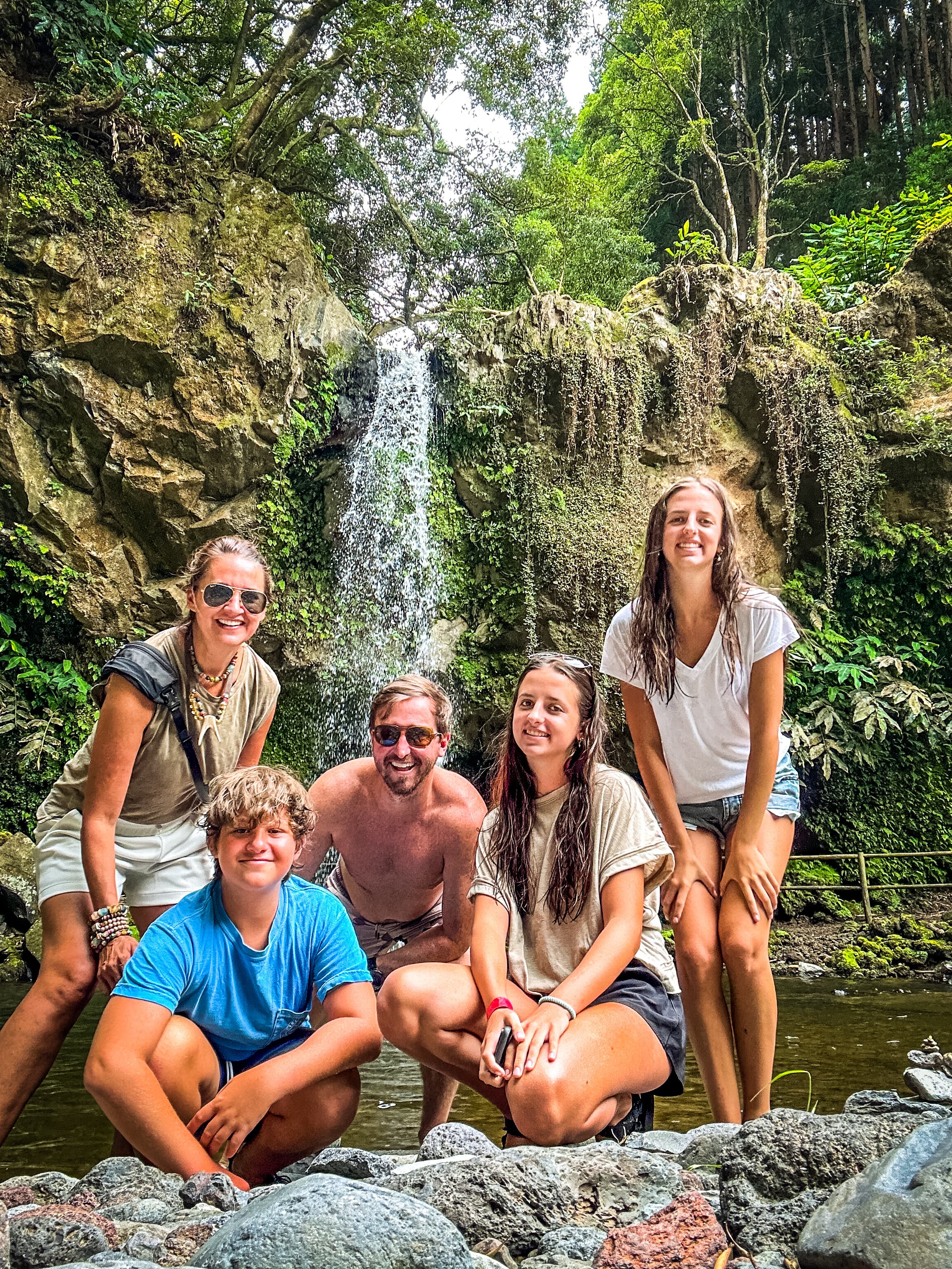 Group picture by a waterfall.