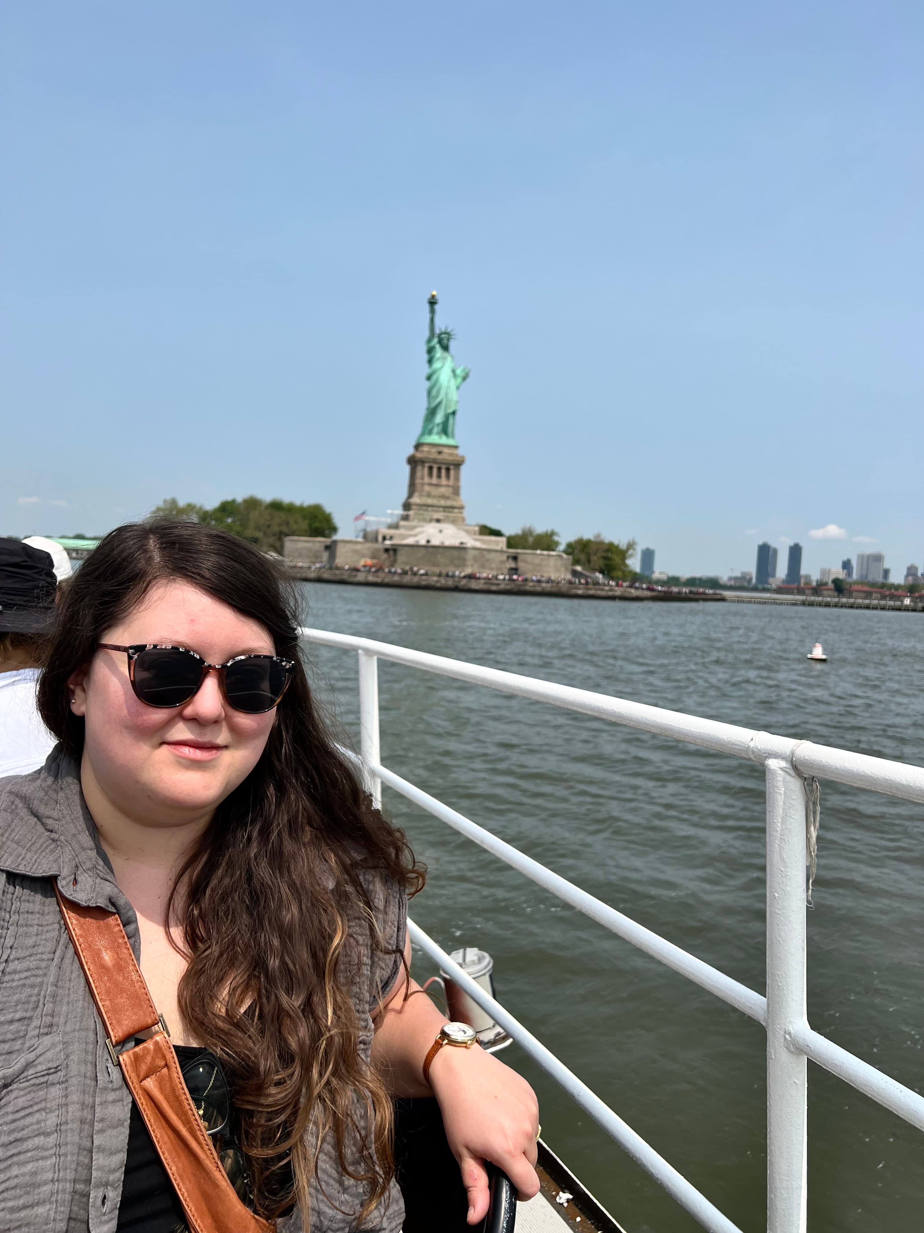 Advisor standing on a ferry with the Statue of Liberty in the distance.
