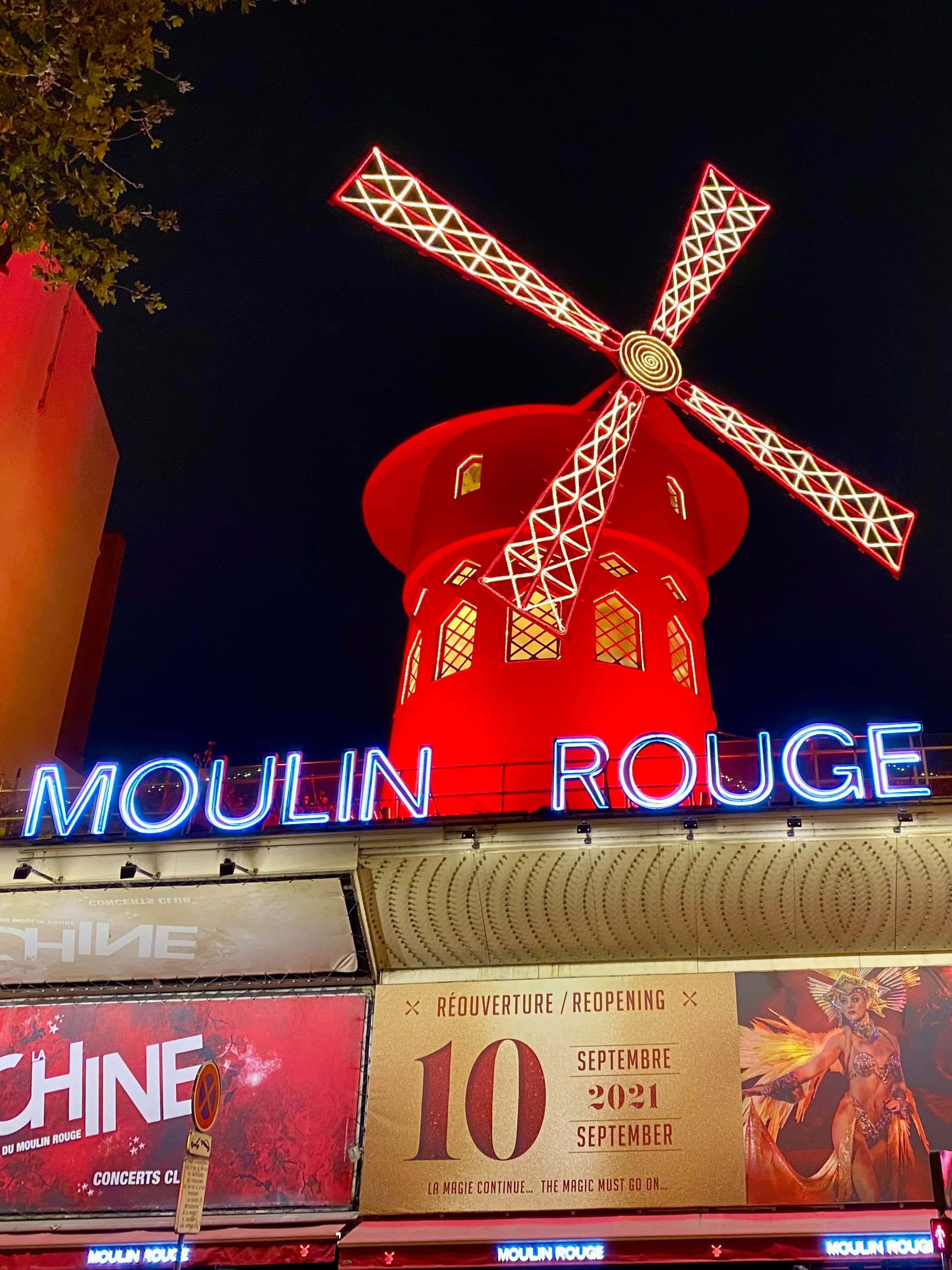 A view of Moulin Rouge lit up at night in Paris.