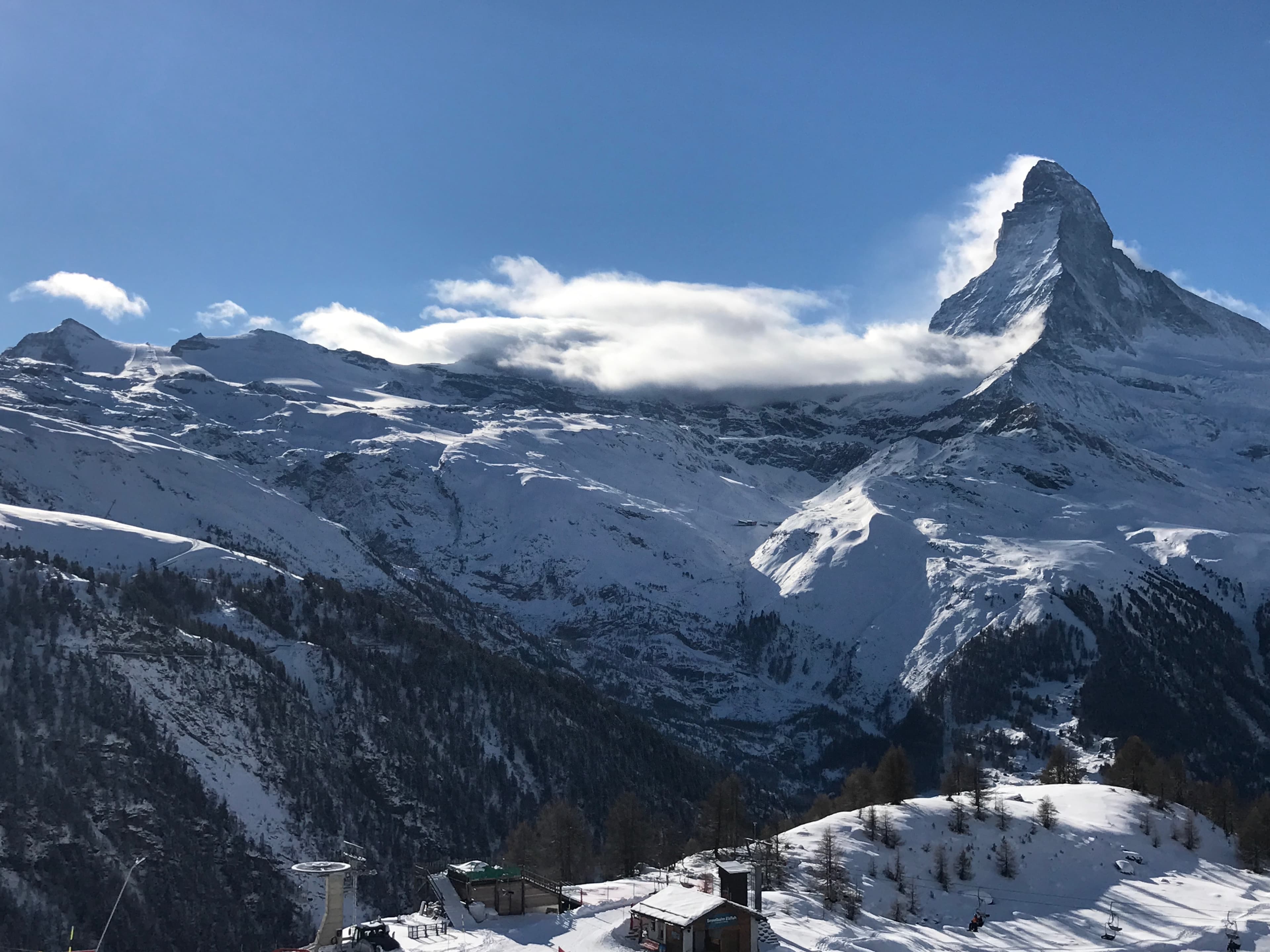 A view of snow capped mountains during the daytime.