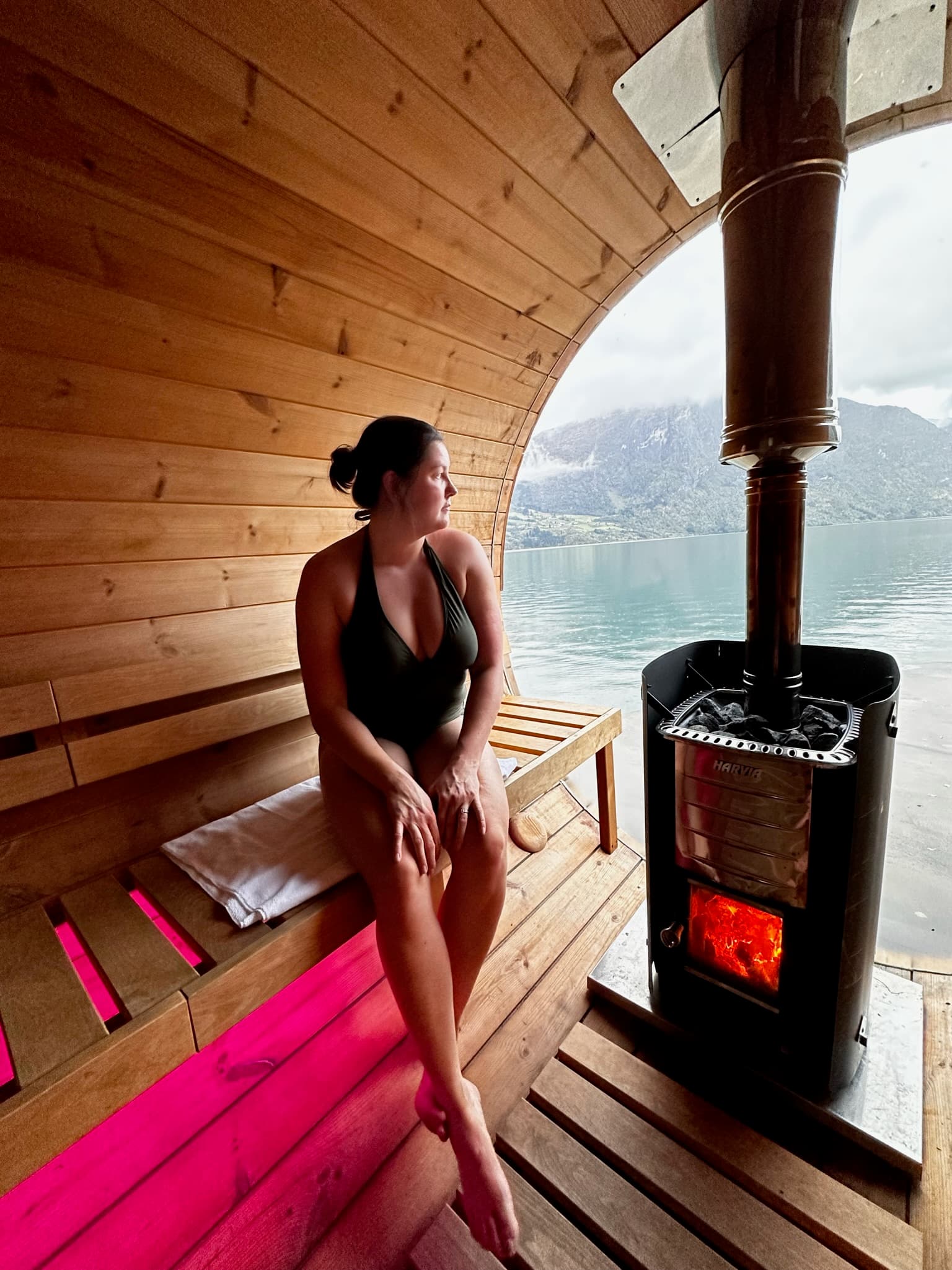 View of advisor in a sauna overlooking a lake in a cold environment