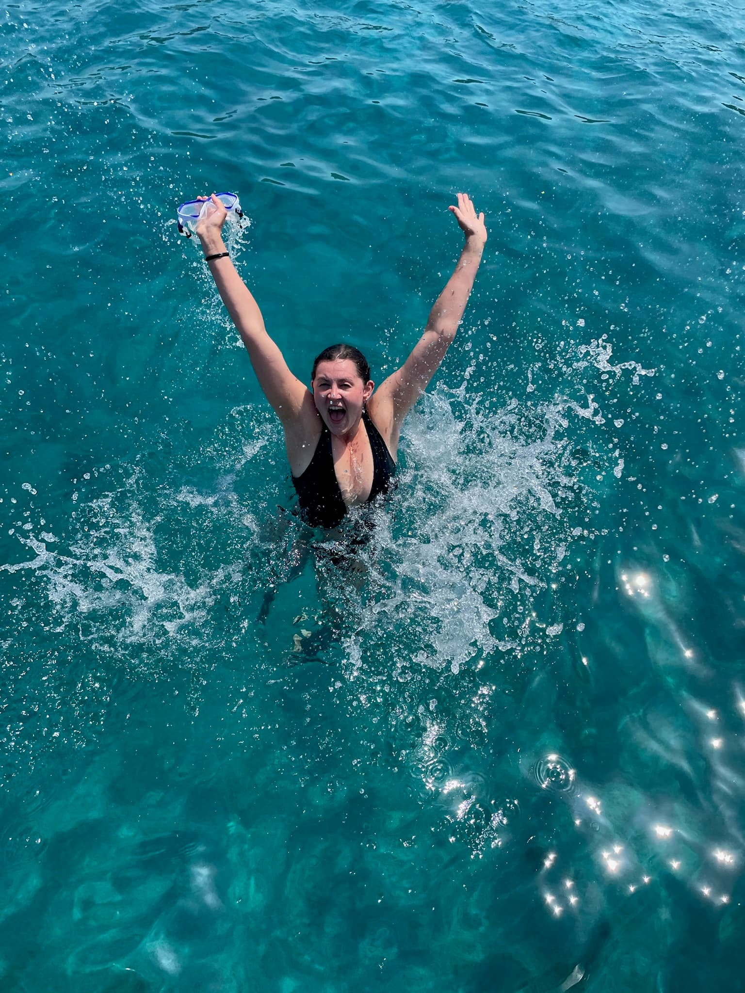 Advisor in the ocean with arms raised