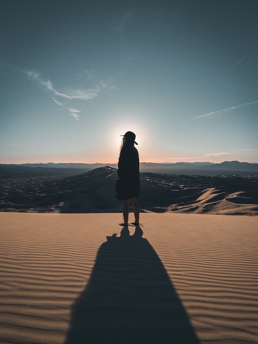 View of advisor in silhouette standing in the desert