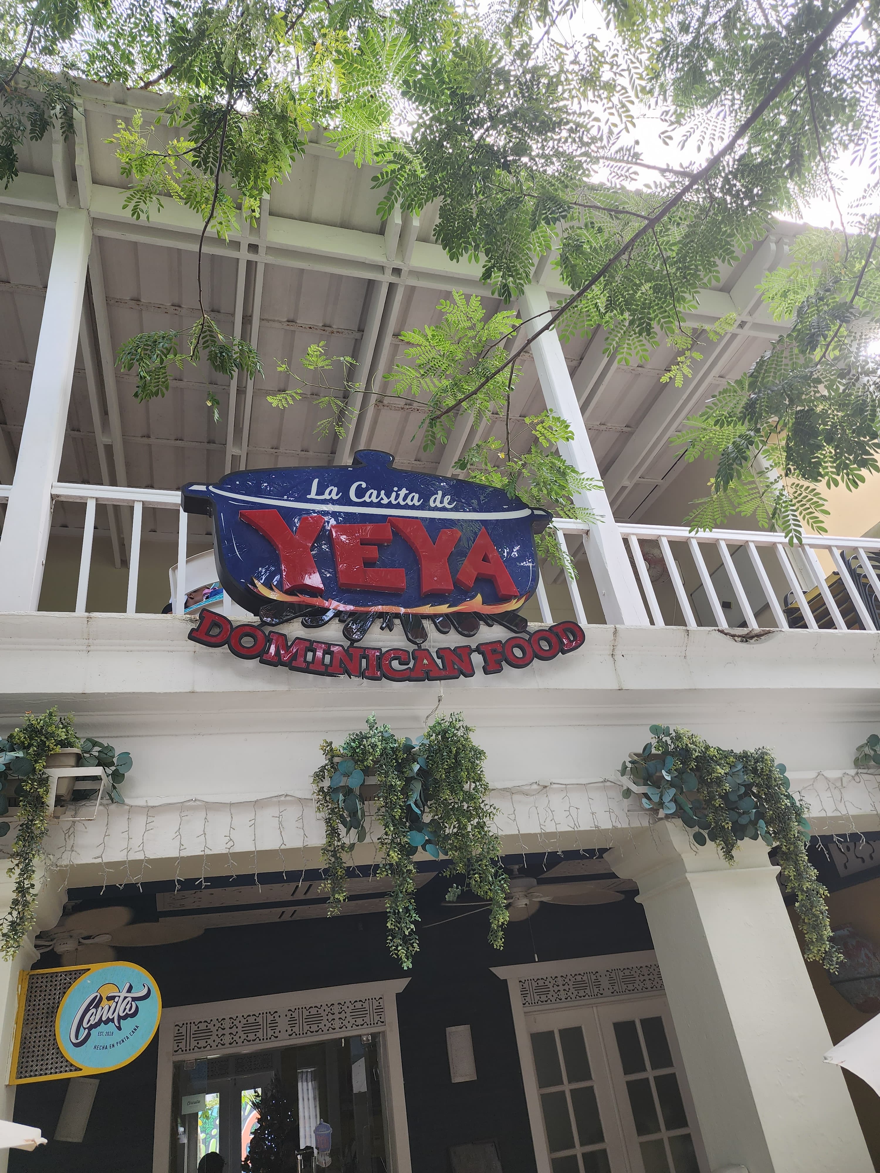 A large white building stands prominently against a clear blue sky, showcasing its elegant architecture and spacious design.