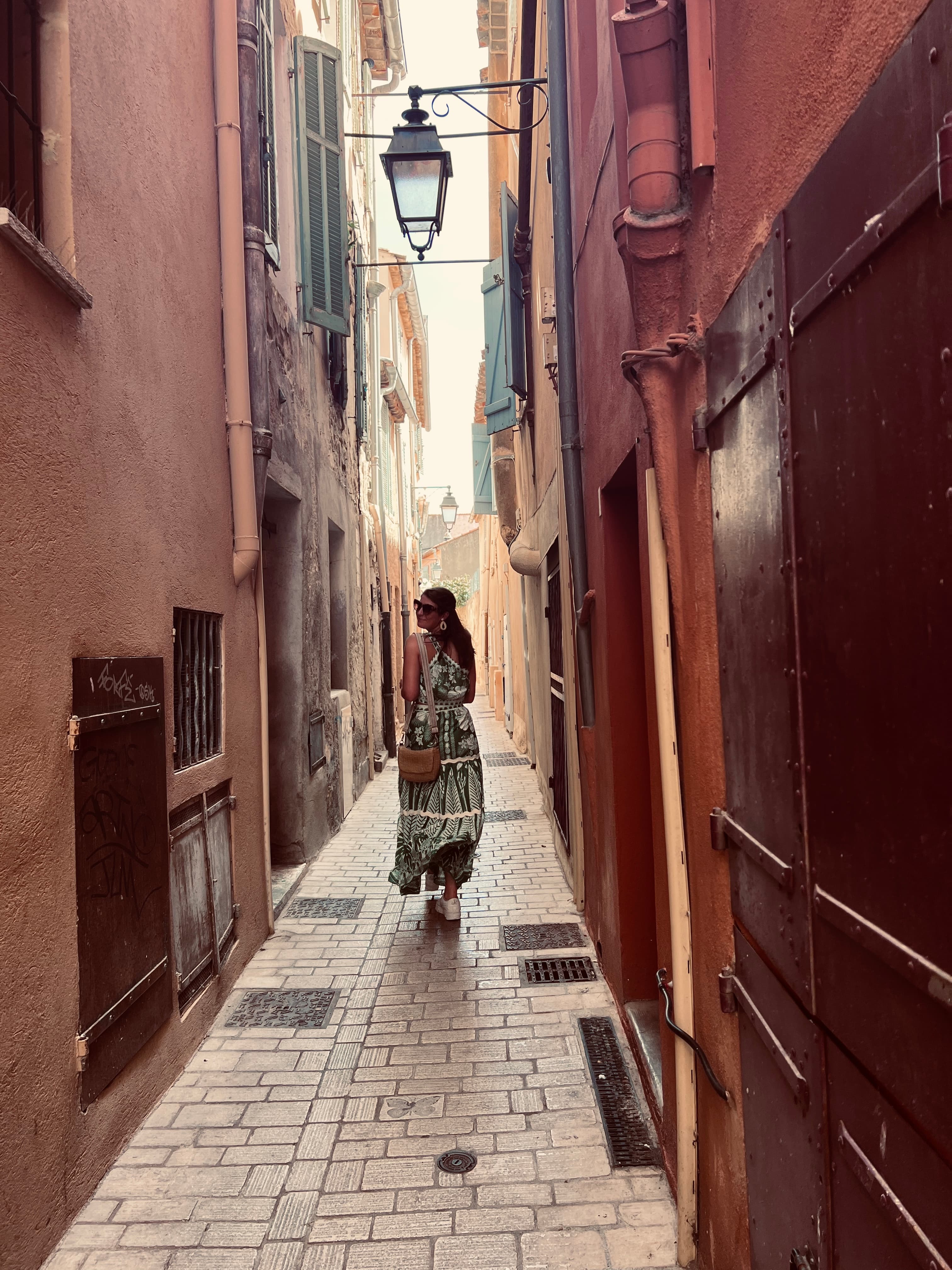 Advisor walking down a narrow street in between old buildings