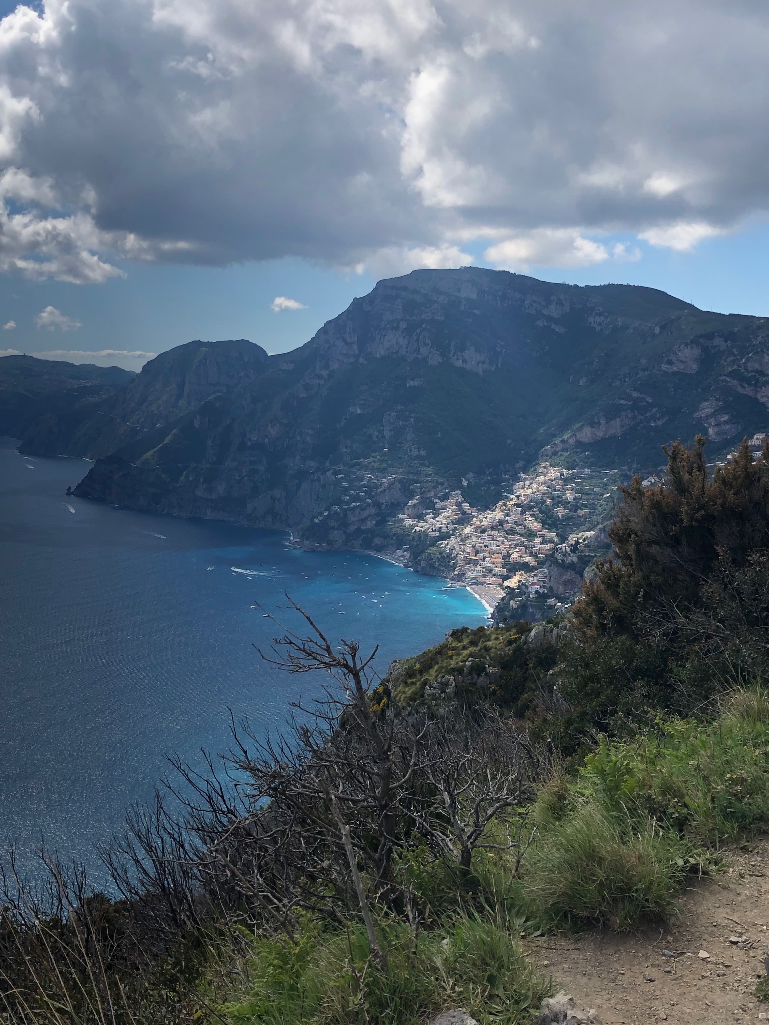 Aerial view of a dramatic coastline under a large cloud
