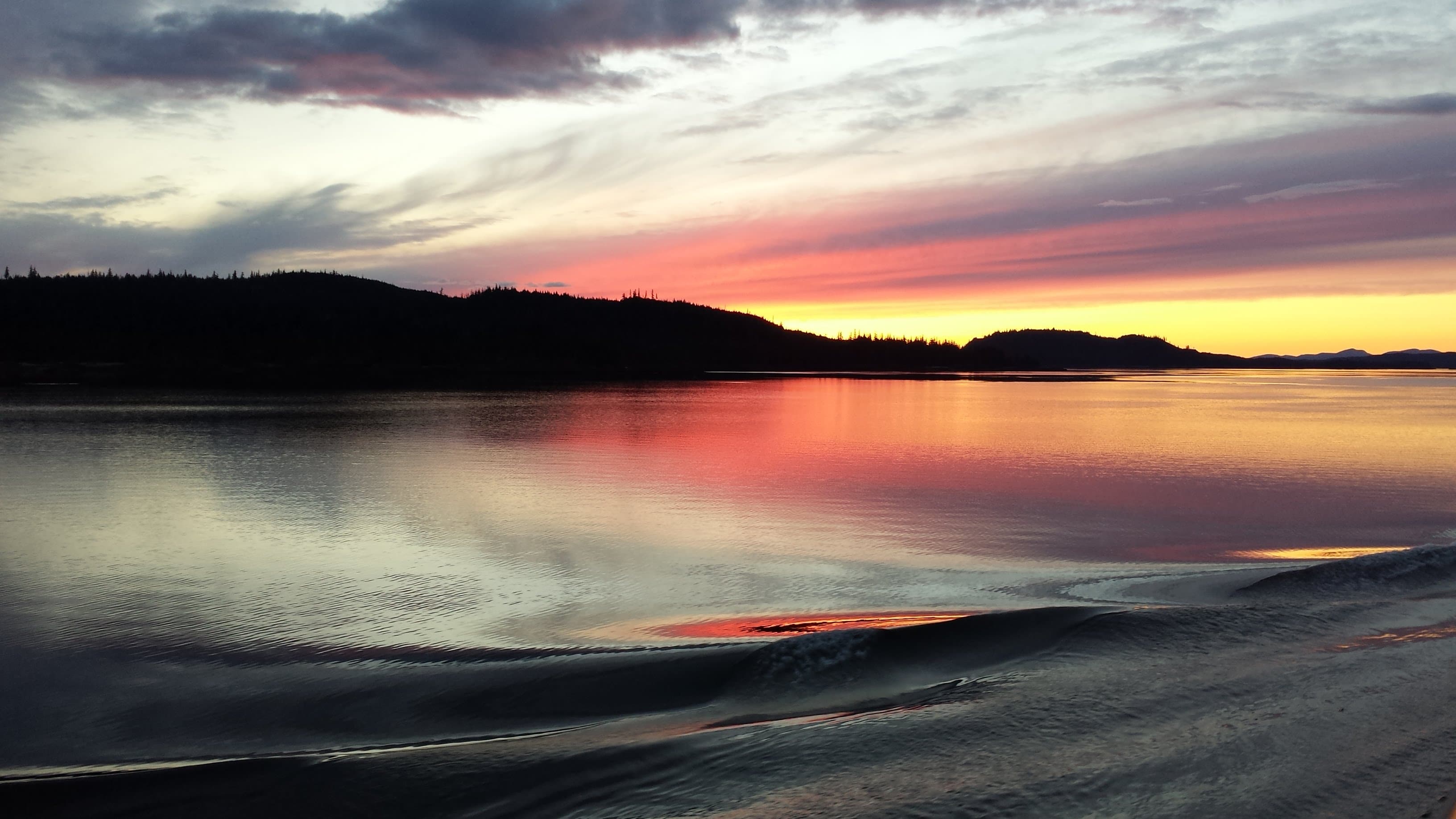 View of a beautiful Alaska sunset over a glassy lake