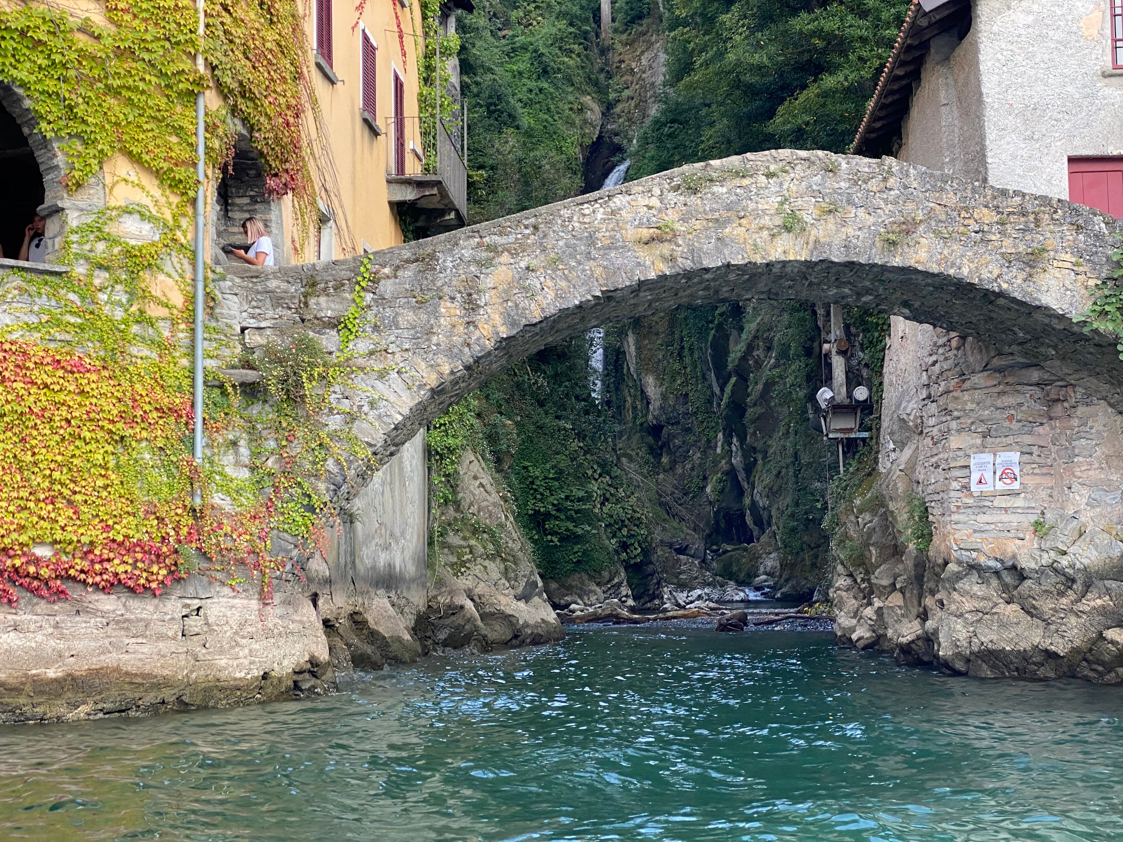 View of a small, old stone bridge over a canal