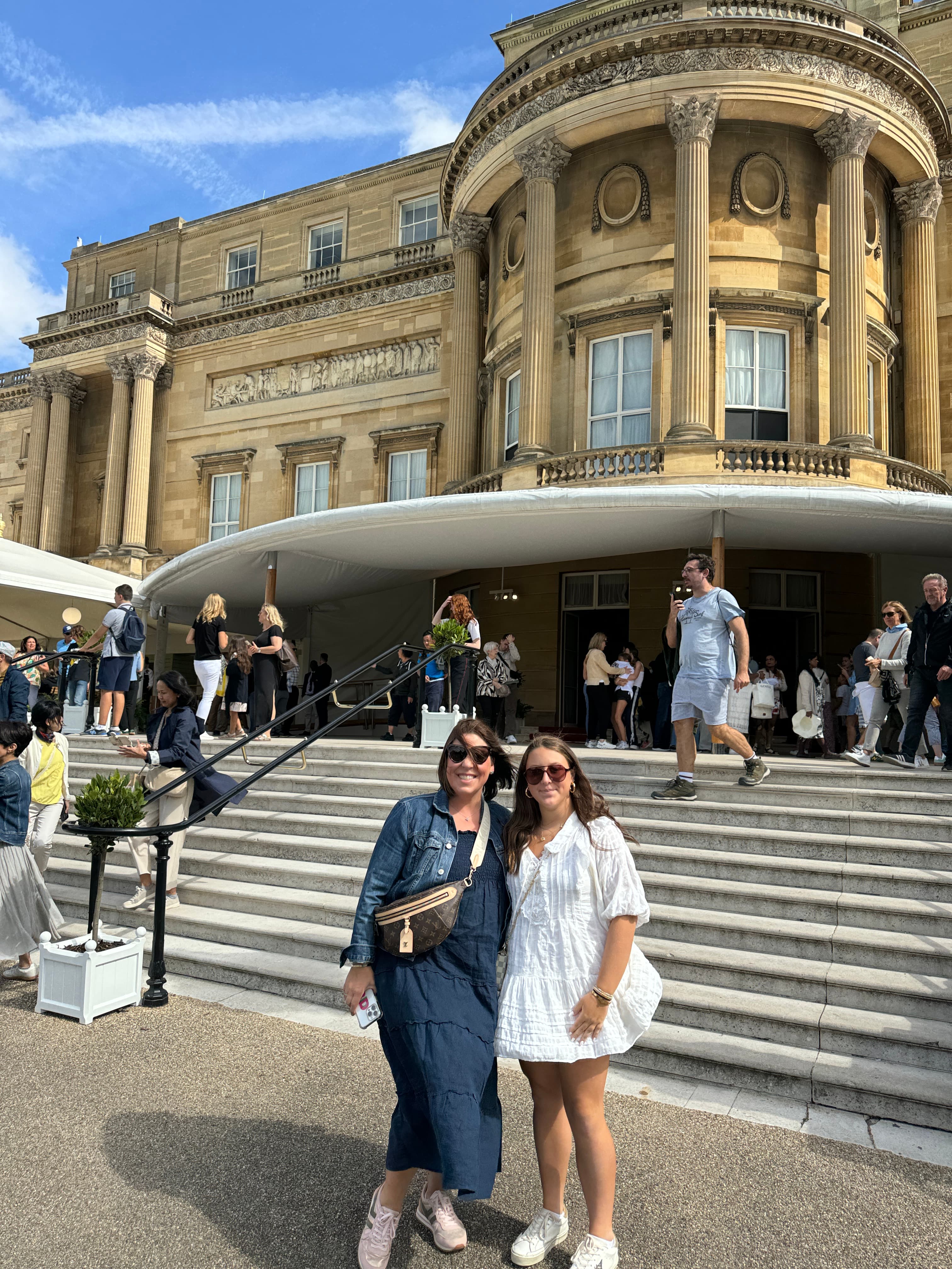 Jessica and friend posing in front of a building during the daytime.