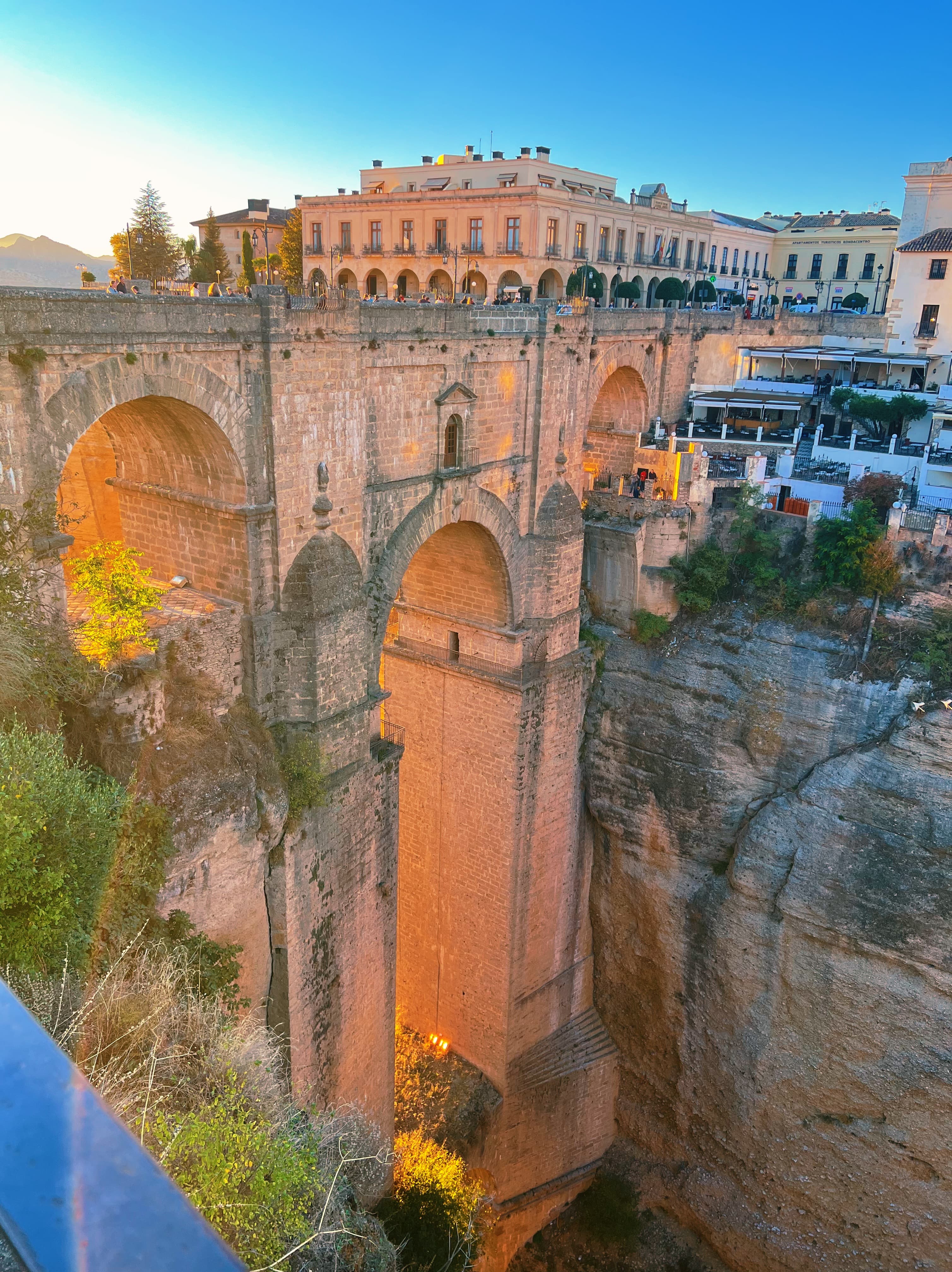 View of a beautiful old bridge built in between a steep canyon on a sunny day