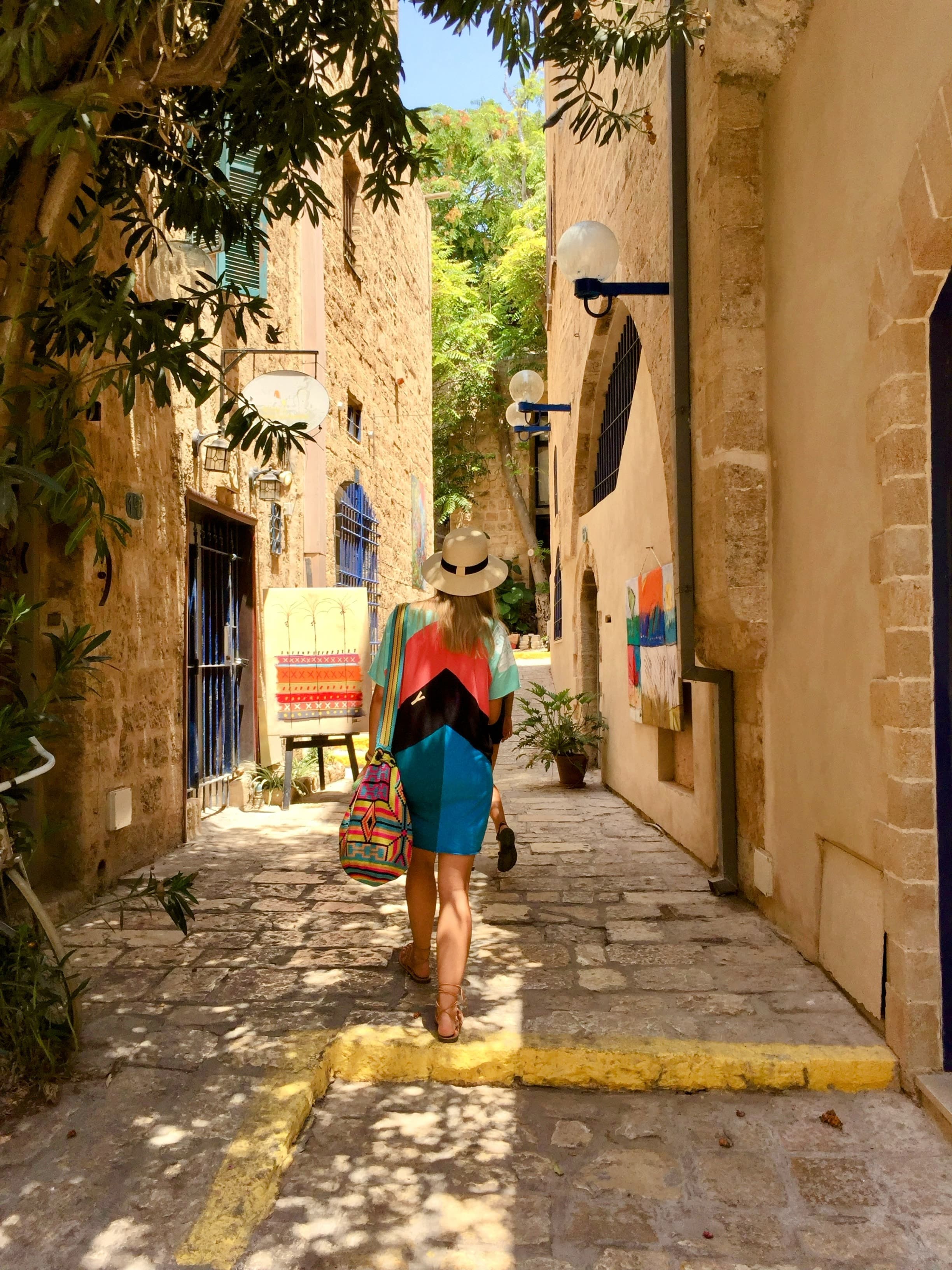 Advisor walking down a sunny cobblestone alley