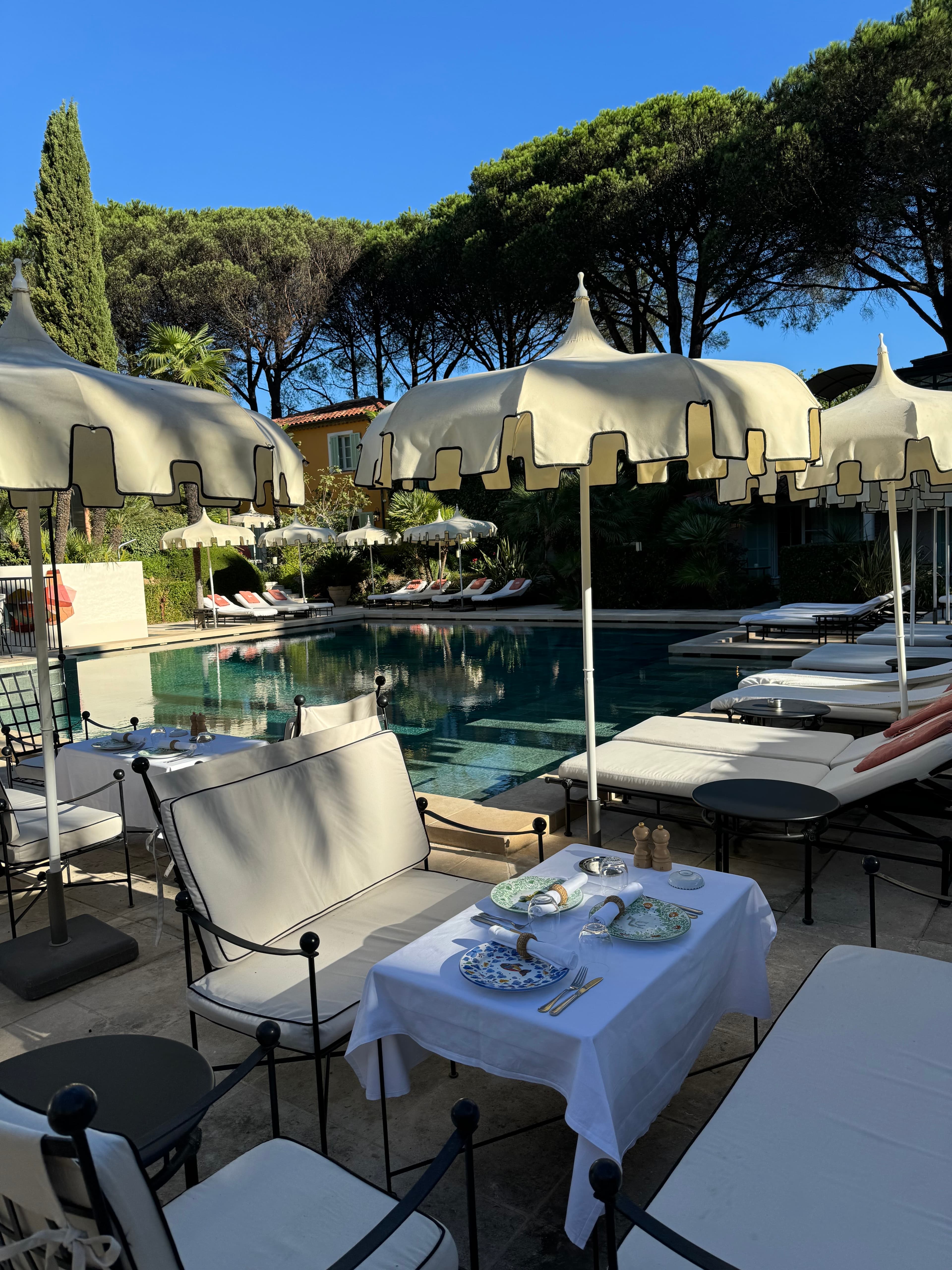 Pool side tables and umbrellas.