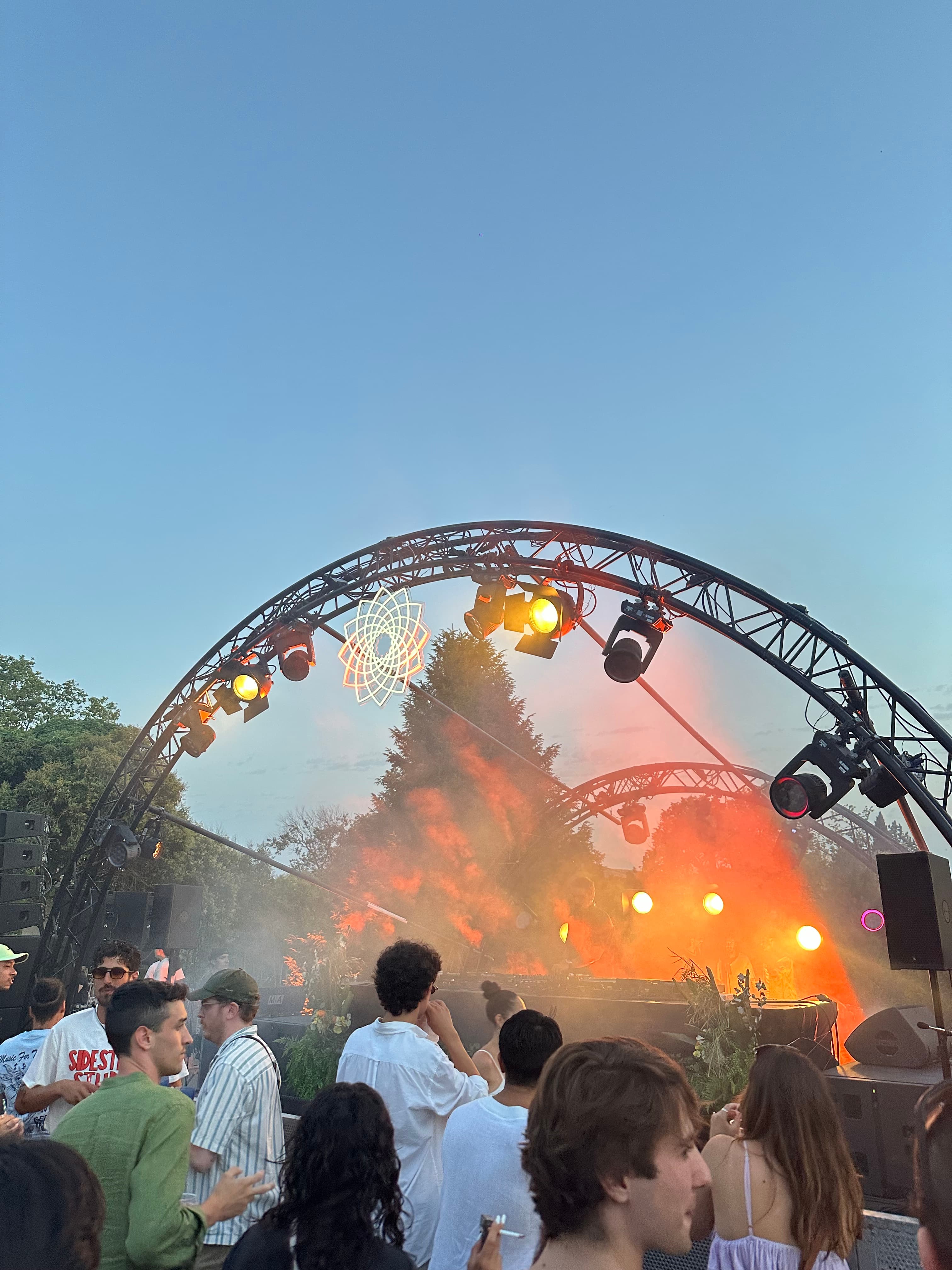 A view of a music concert at dusk.