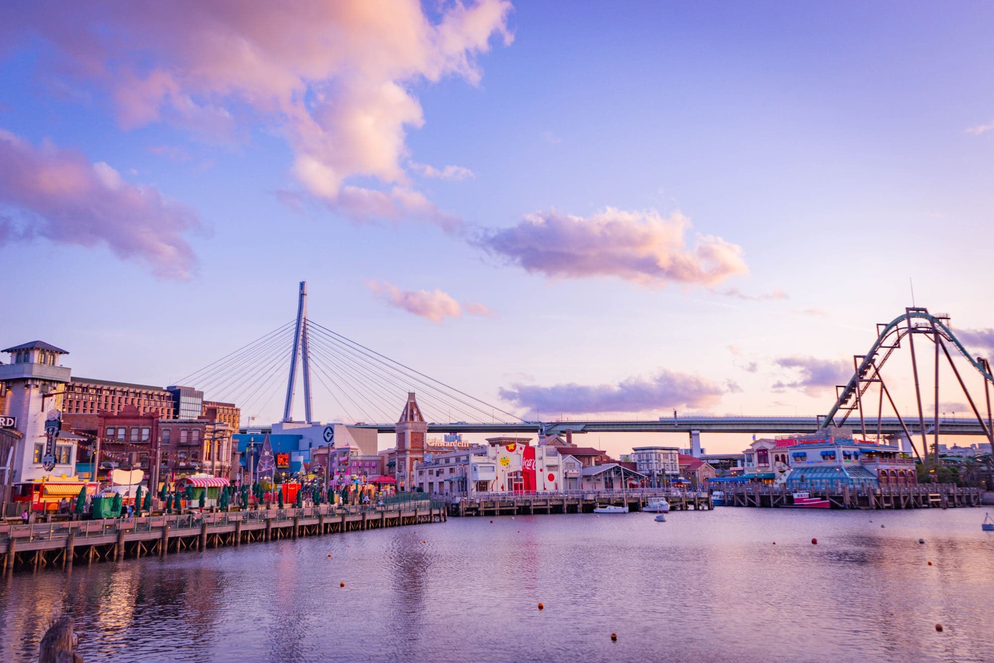 pink sunset over amusement park on the water
