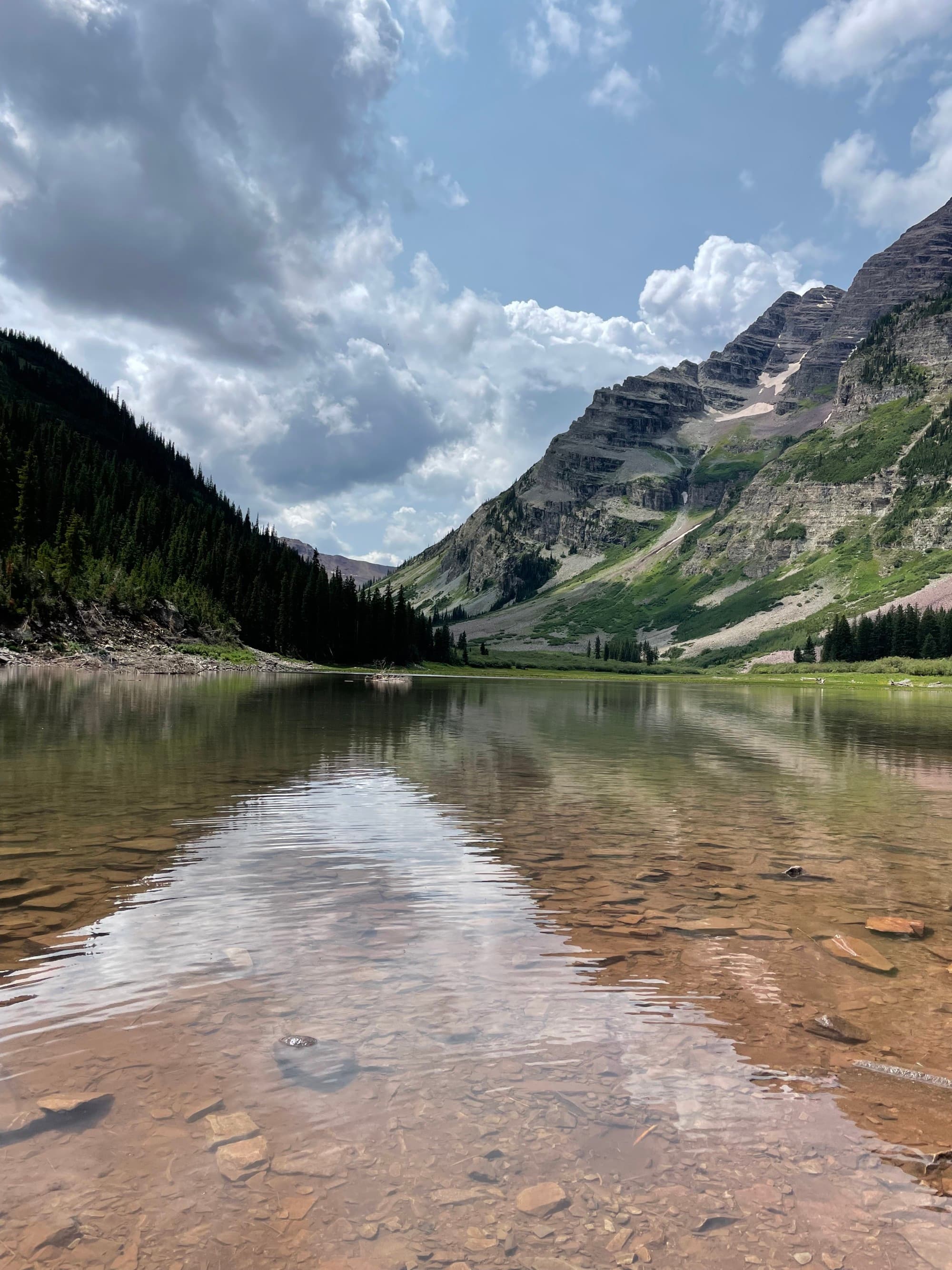A landscape reflected on water, with the photo taken at an angle that makes it hard to distinguish where the land ends and the reflection begins, taken during a hiking trip in Aspen, Colorado.