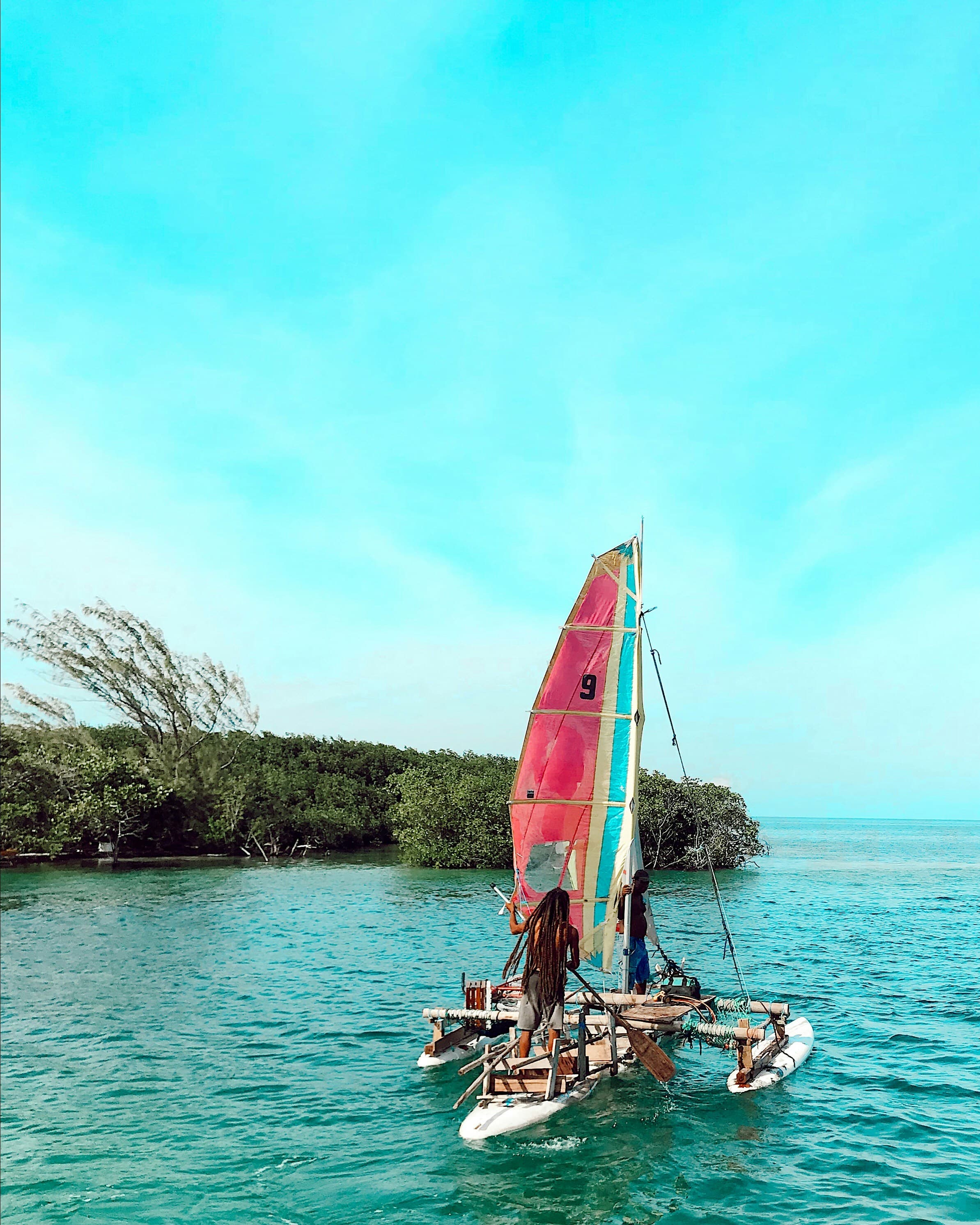 A person windsurfing in an ocean cove during the day.