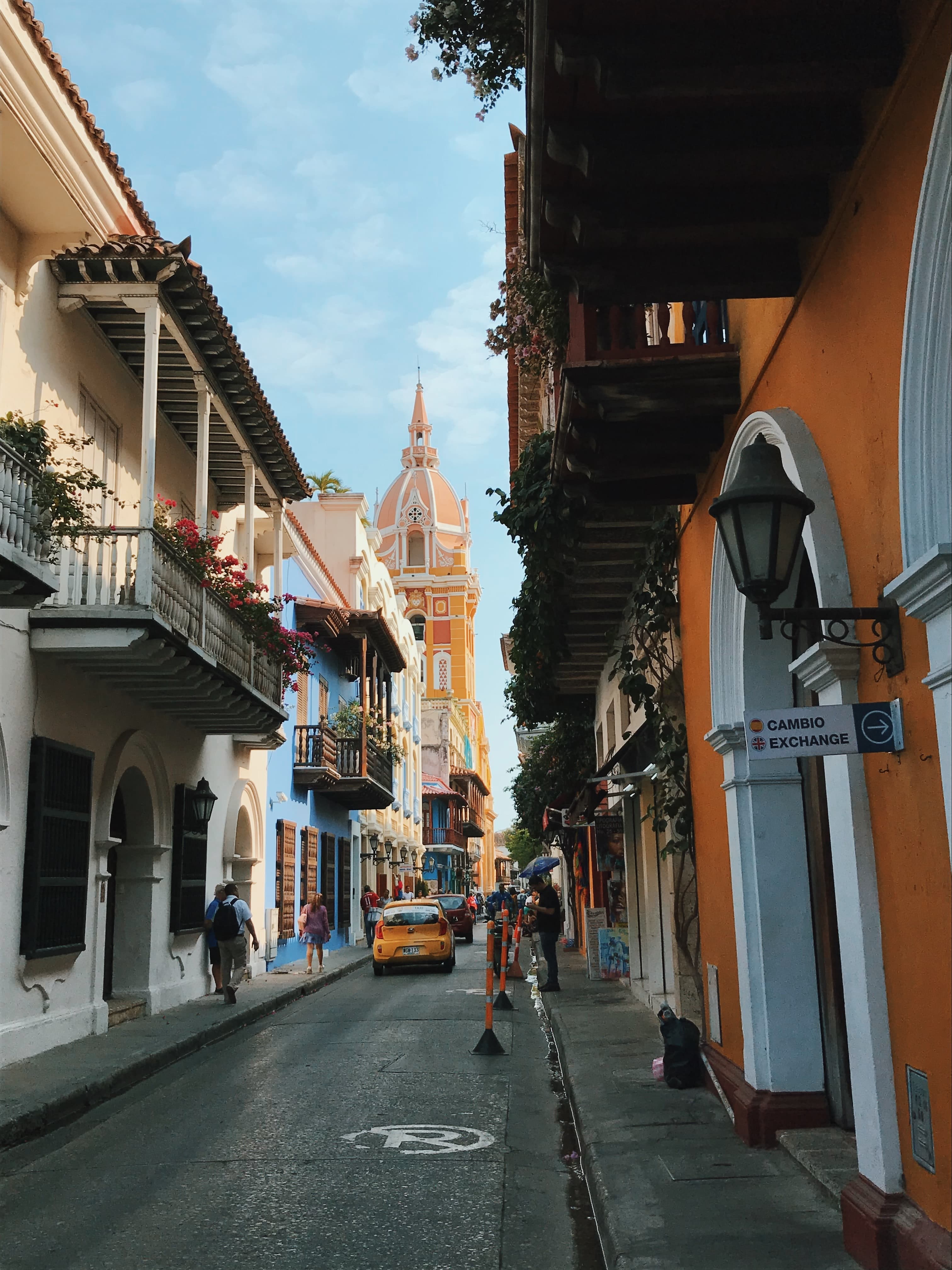 colorful historic narrow street with cars at daytime