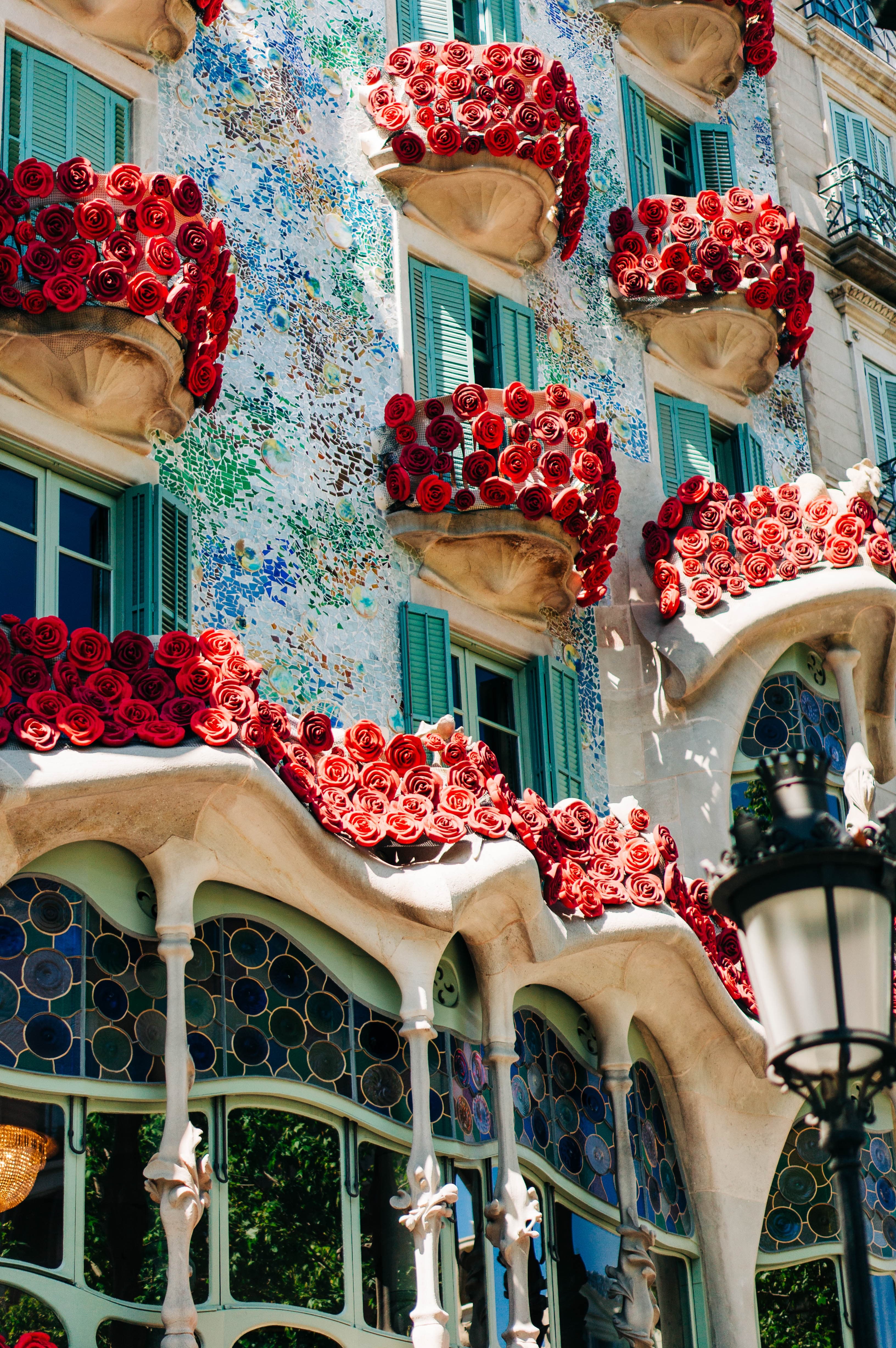 A colorful and tiled facade of one of Gaudi architectural marvels.