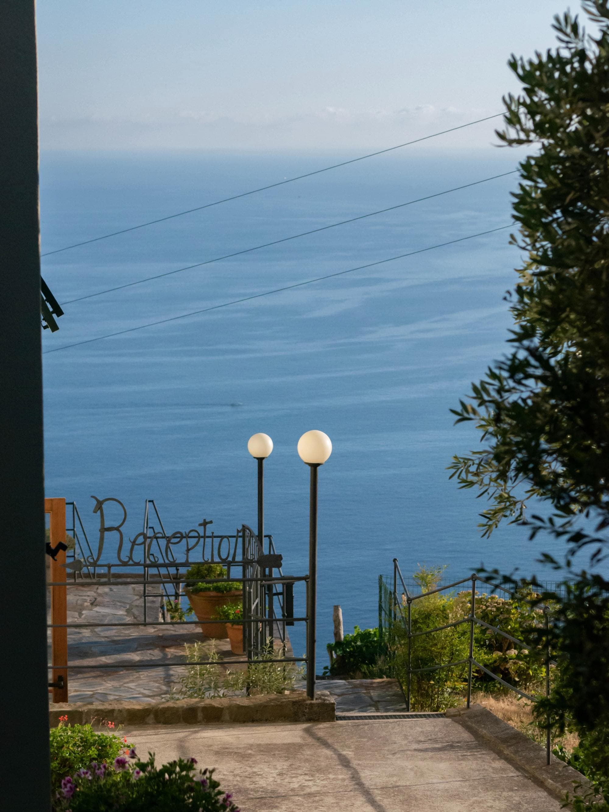 view into the vast ocean from a hilltop hotel reception balcony on a sunnday