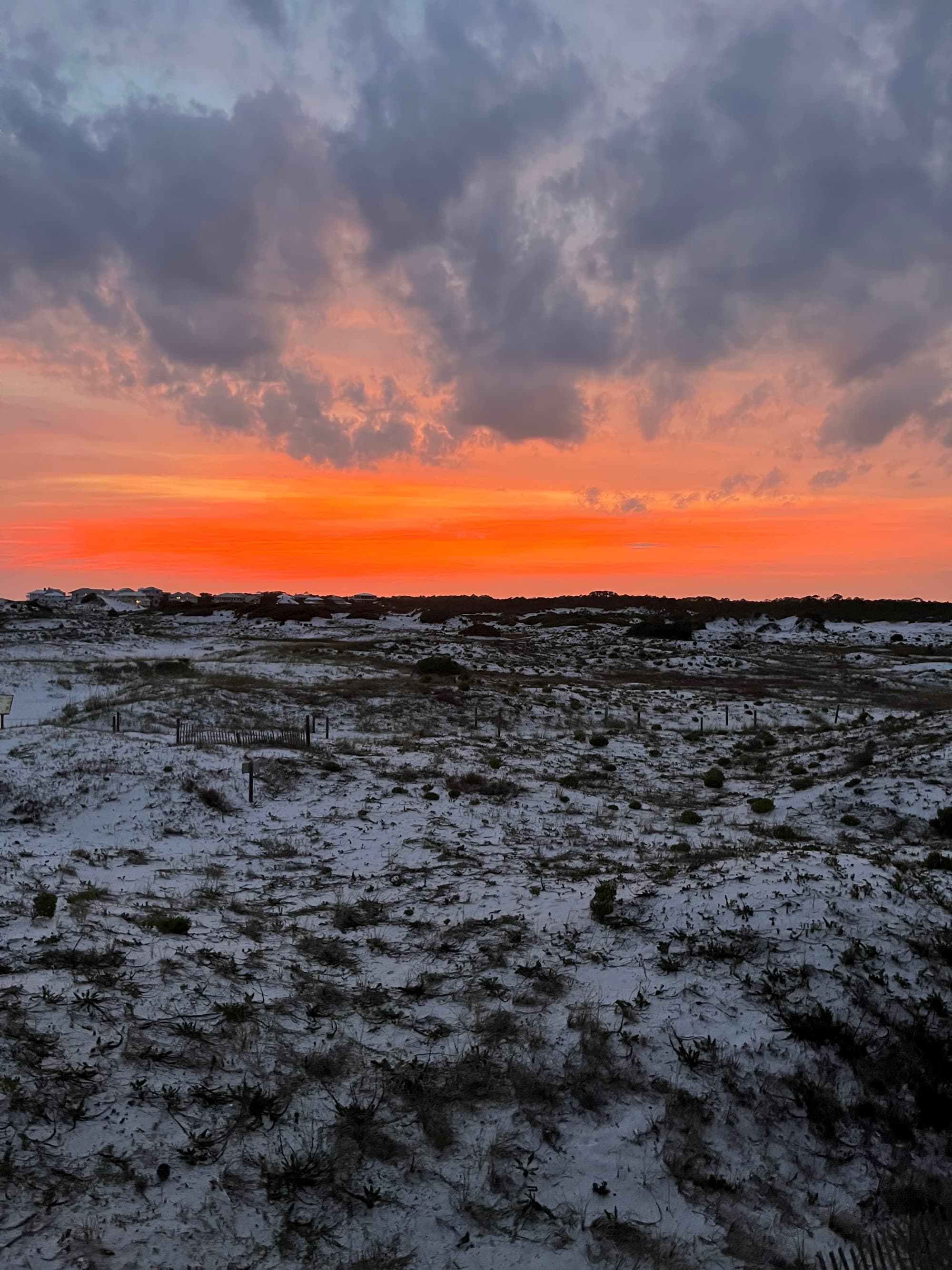 A picture of sunset over a dune on the beach
