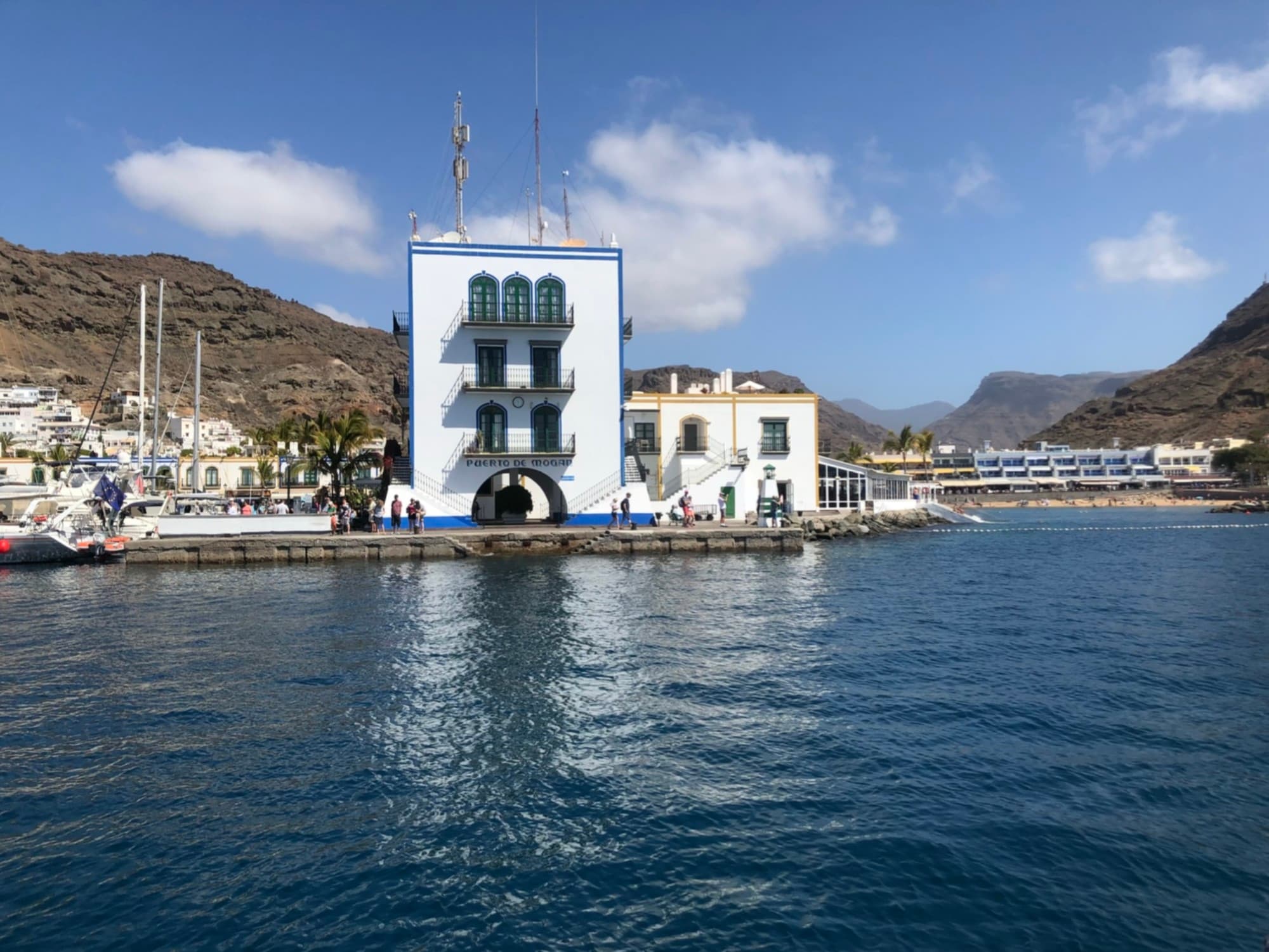 A seashore with white color building and small houses.