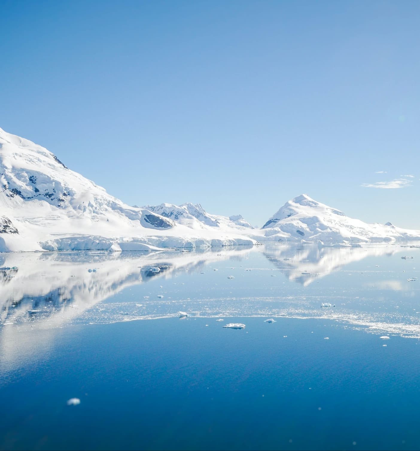 Mountain with snow near body of water is the beauty of Antarctica.