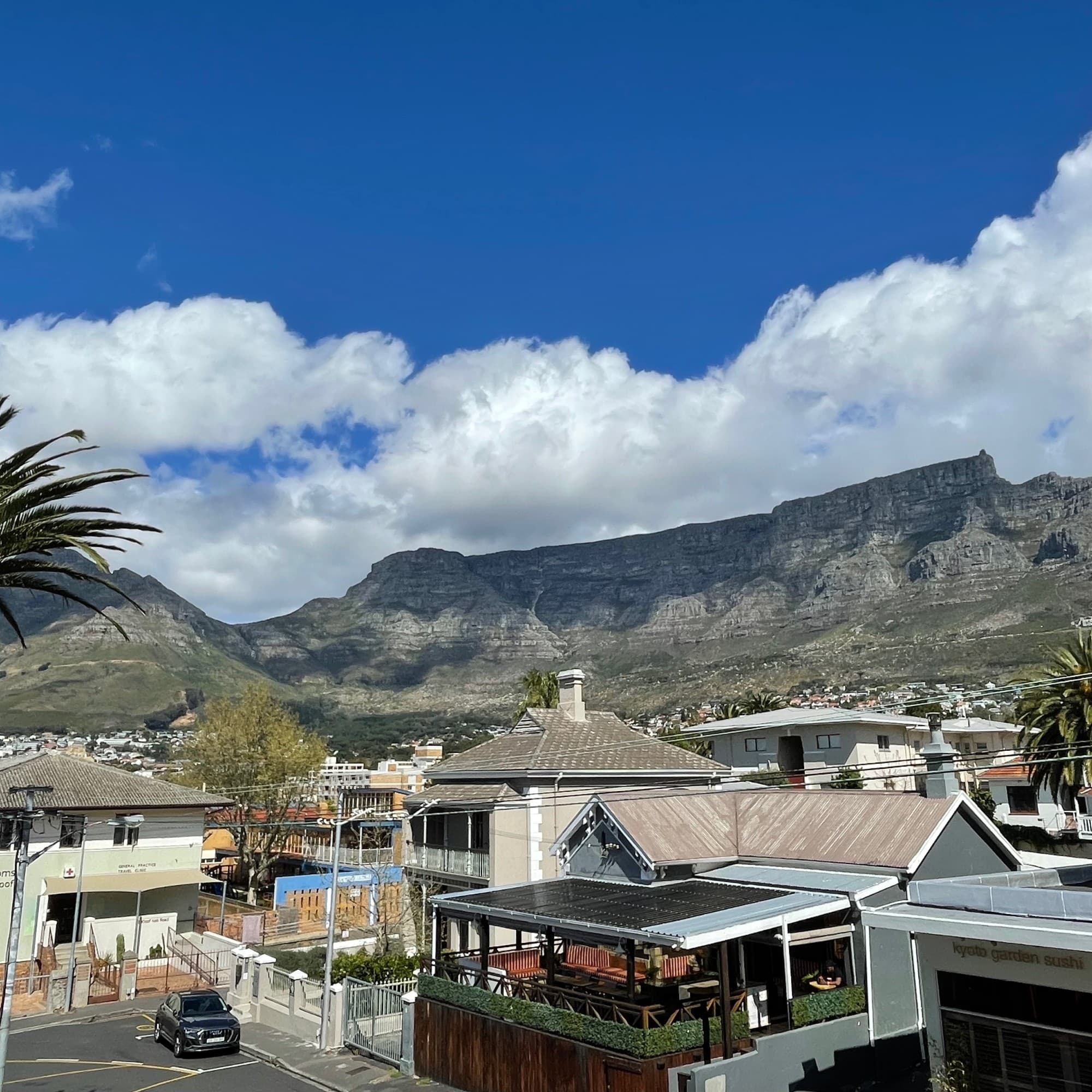 Buildings with mountains at the back.