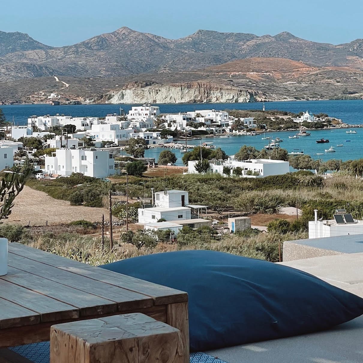 View of water body, city buildings and mountains from a roof top.