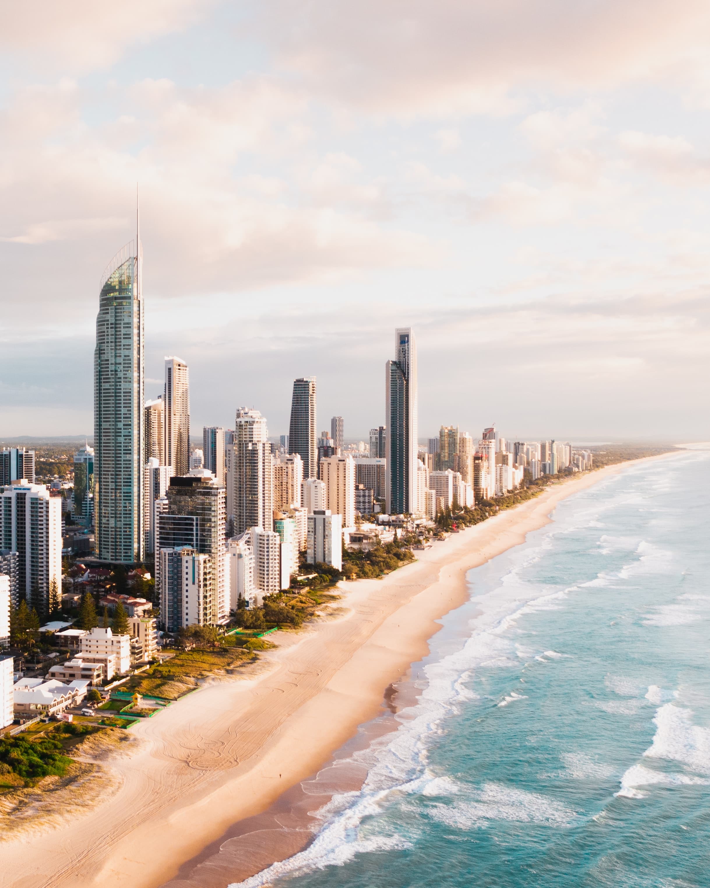 skyscrapers next to beach and ocean during sunset