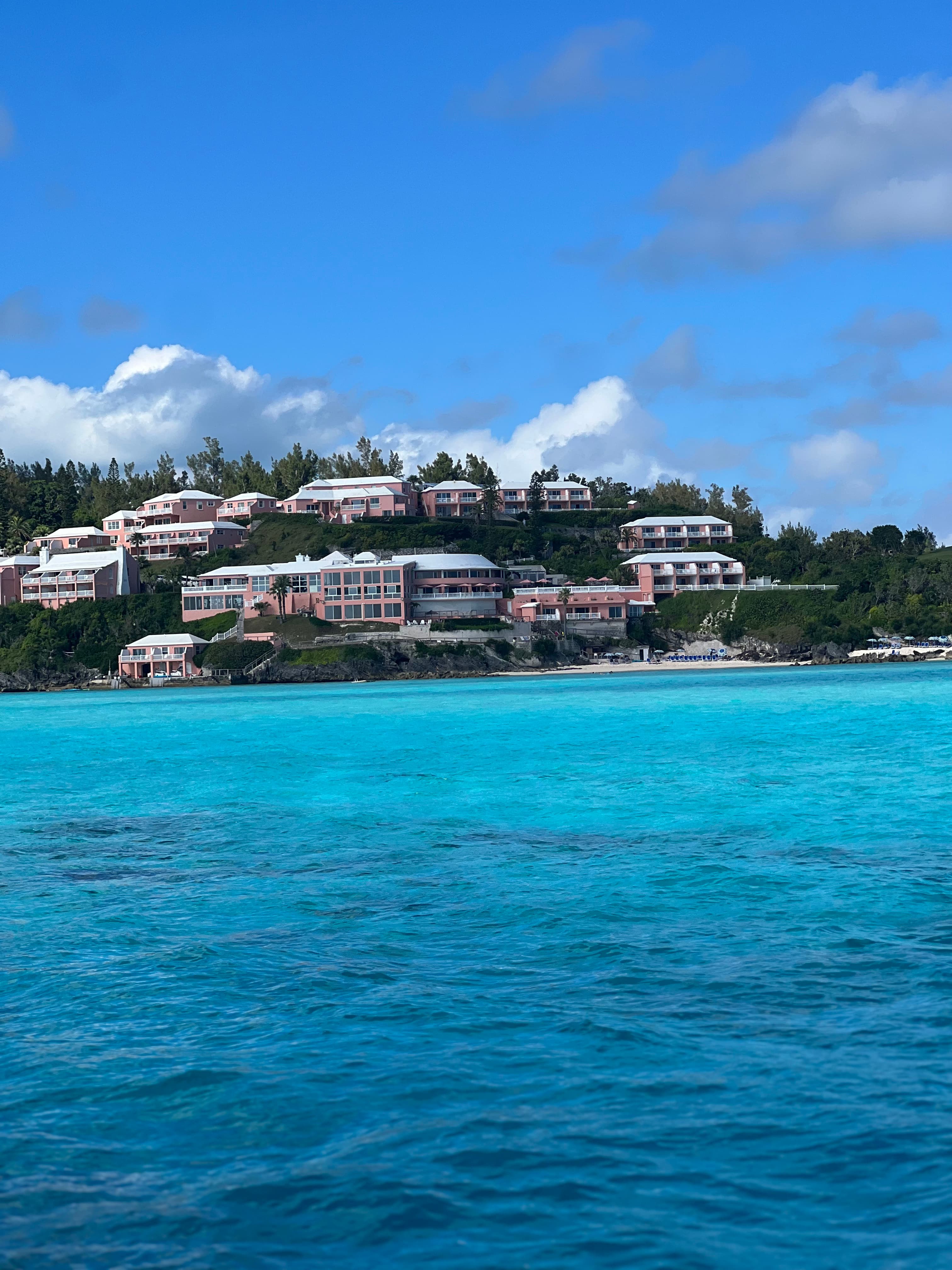 Blue water with multiple houses on the background