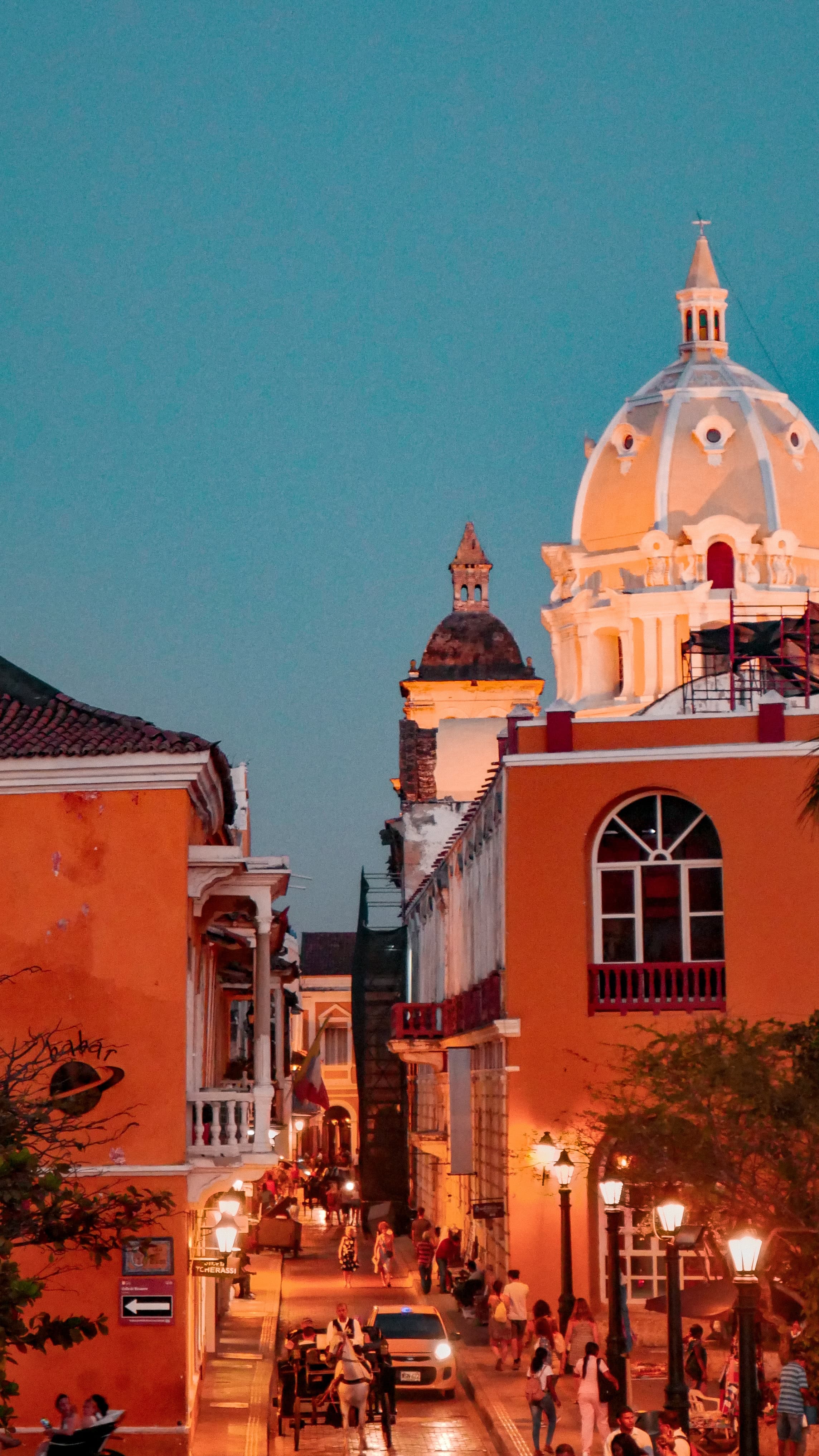 orange buildings next to street during nighttime