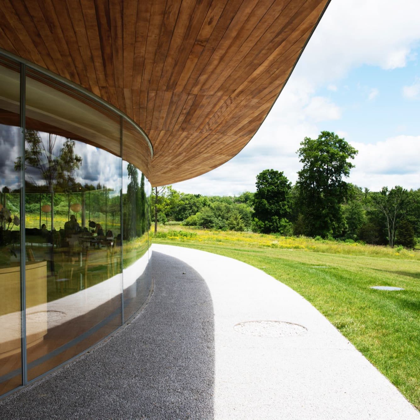 Green field near a circular building with brown shade.