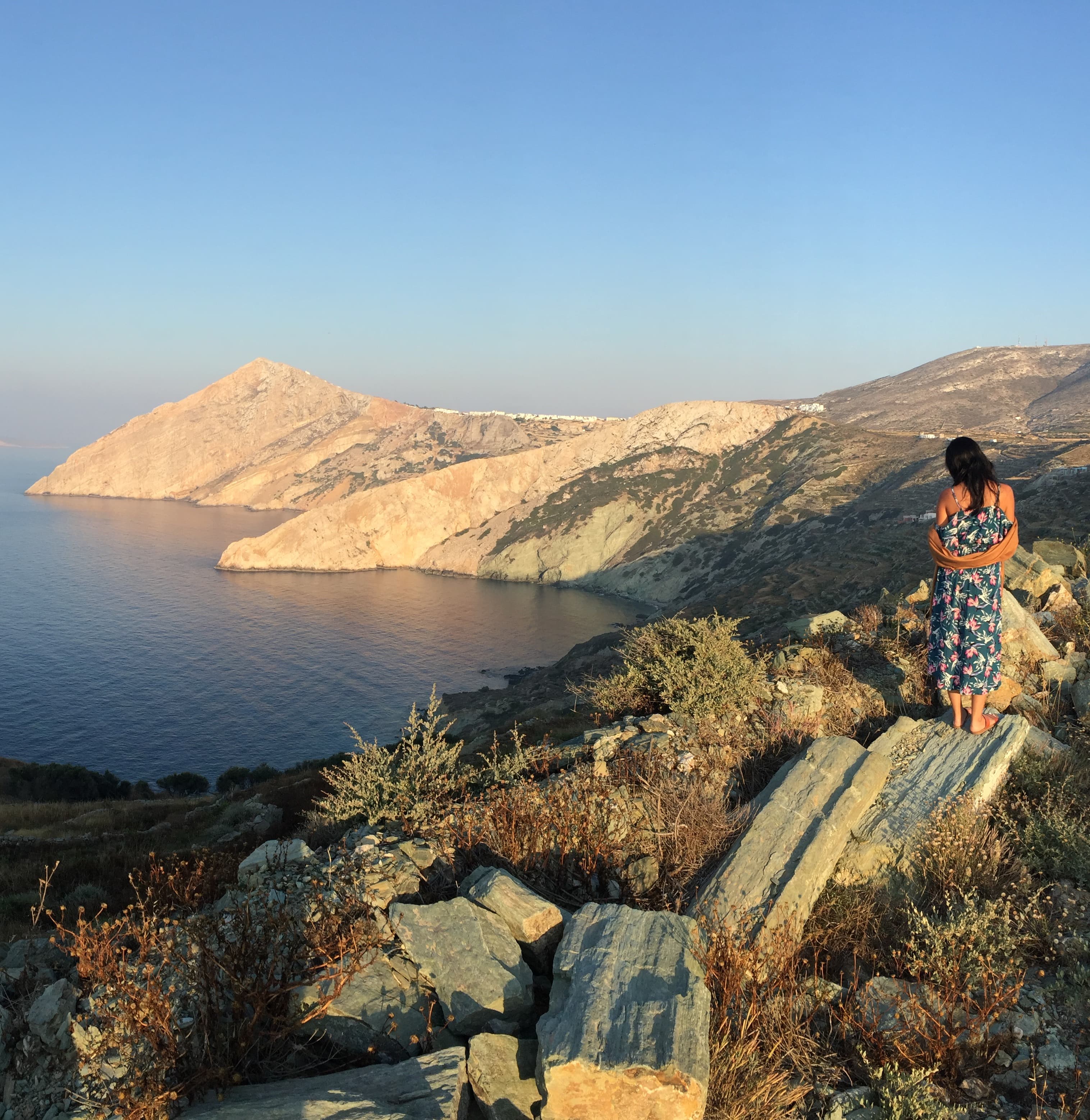 travel advisor Daphne Lin stands on top of a island cliff