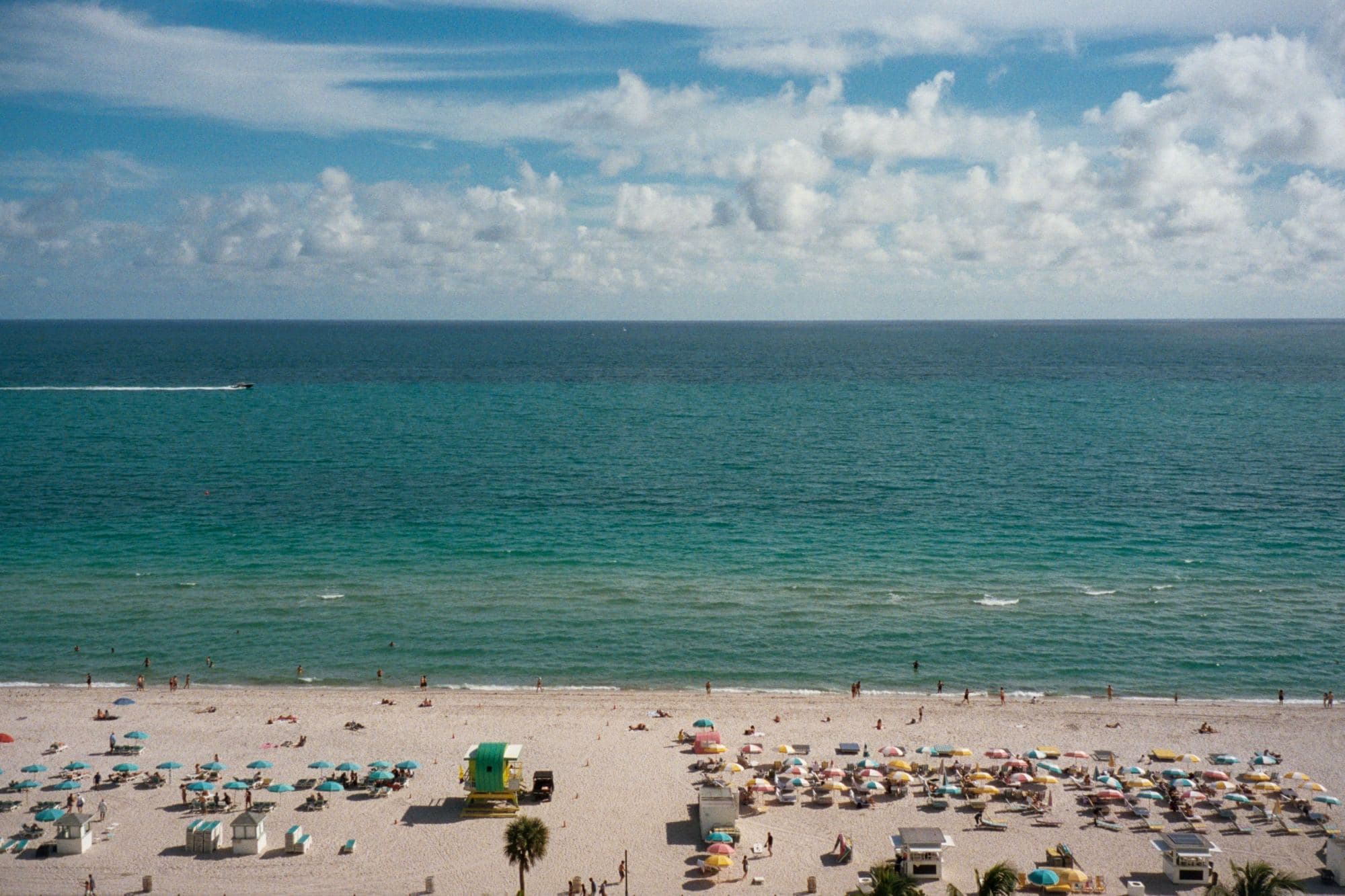 beach with lines of colorful umbrellas