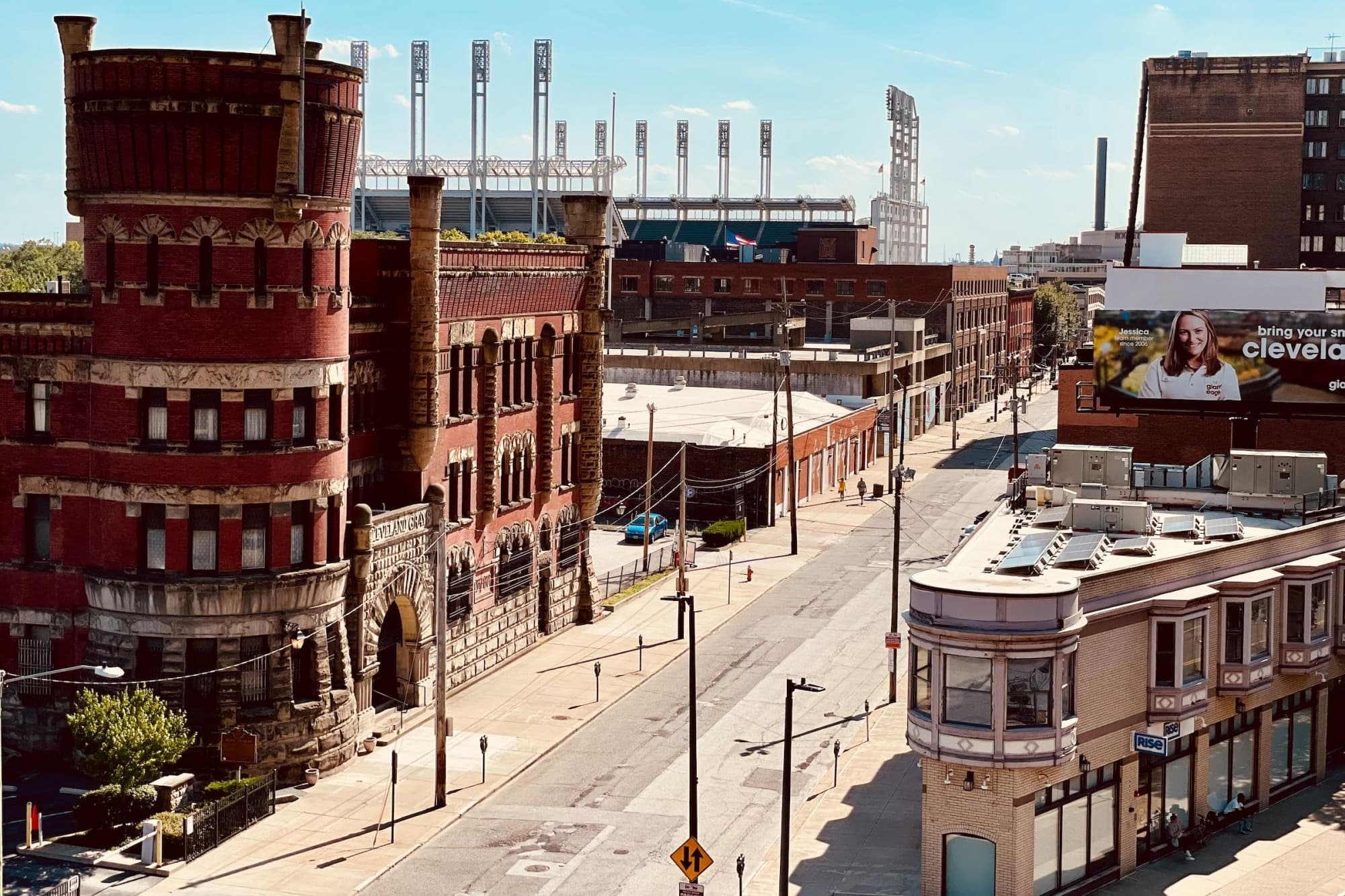 Downtown Cleveland with a fun castle-like building and Cleveland Browns Stadium poking out over the top of the buildings in the foreground.