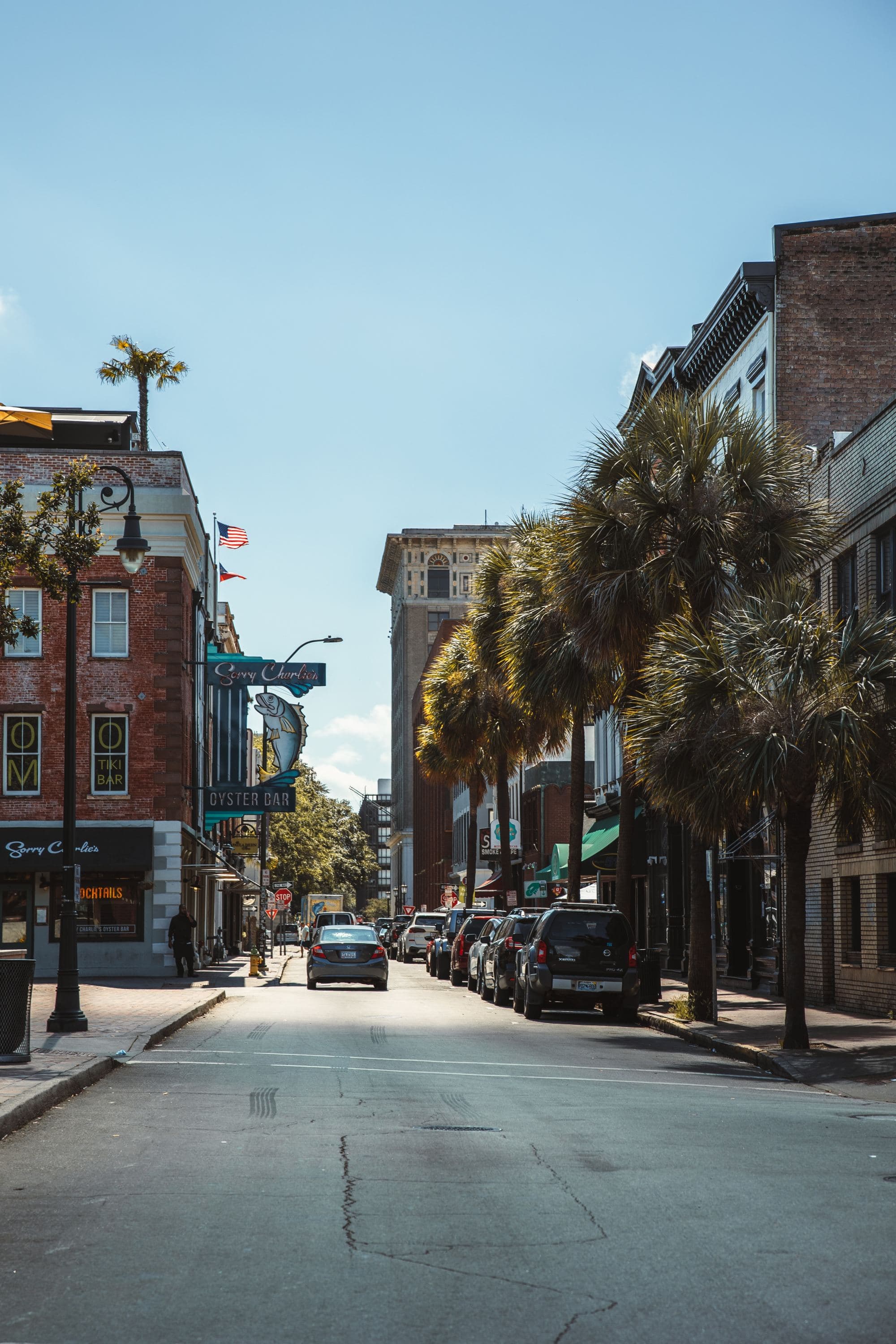 small town street lined with trees on a sunny day