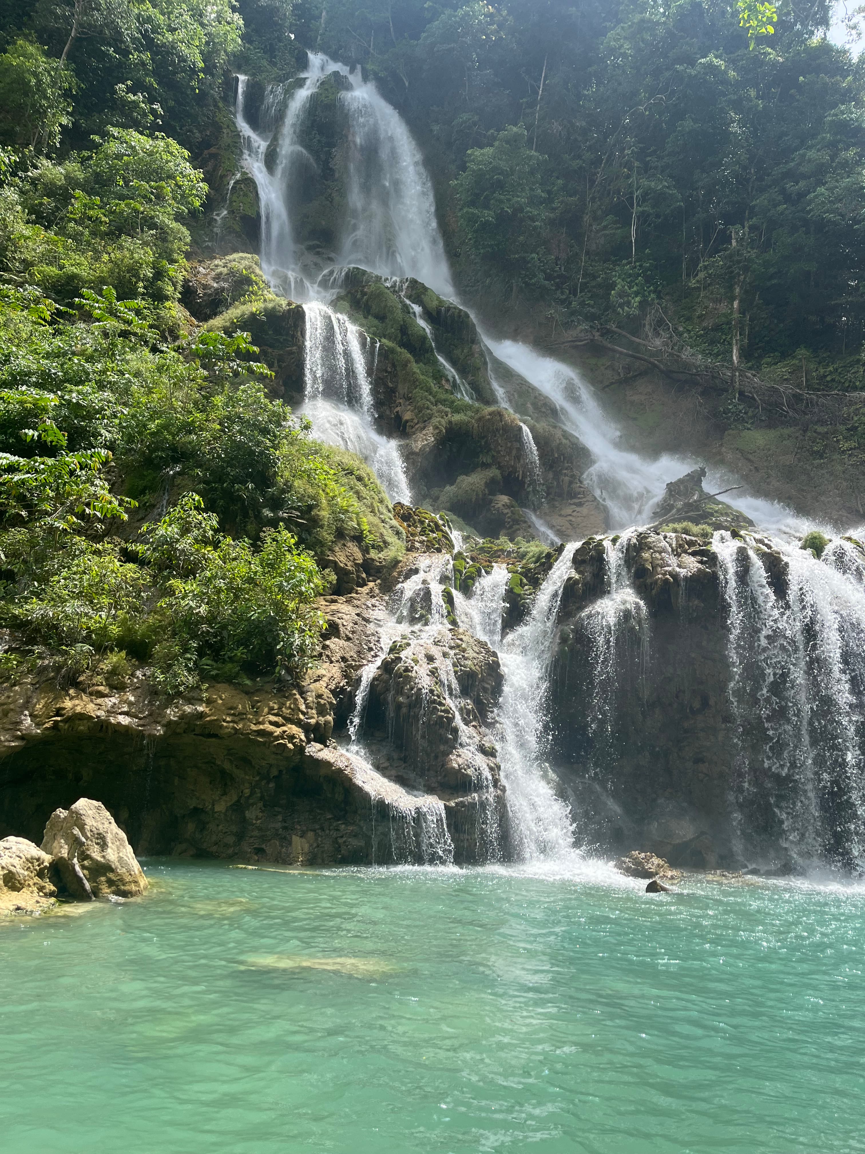 waterfall with large swimming hole during daytime