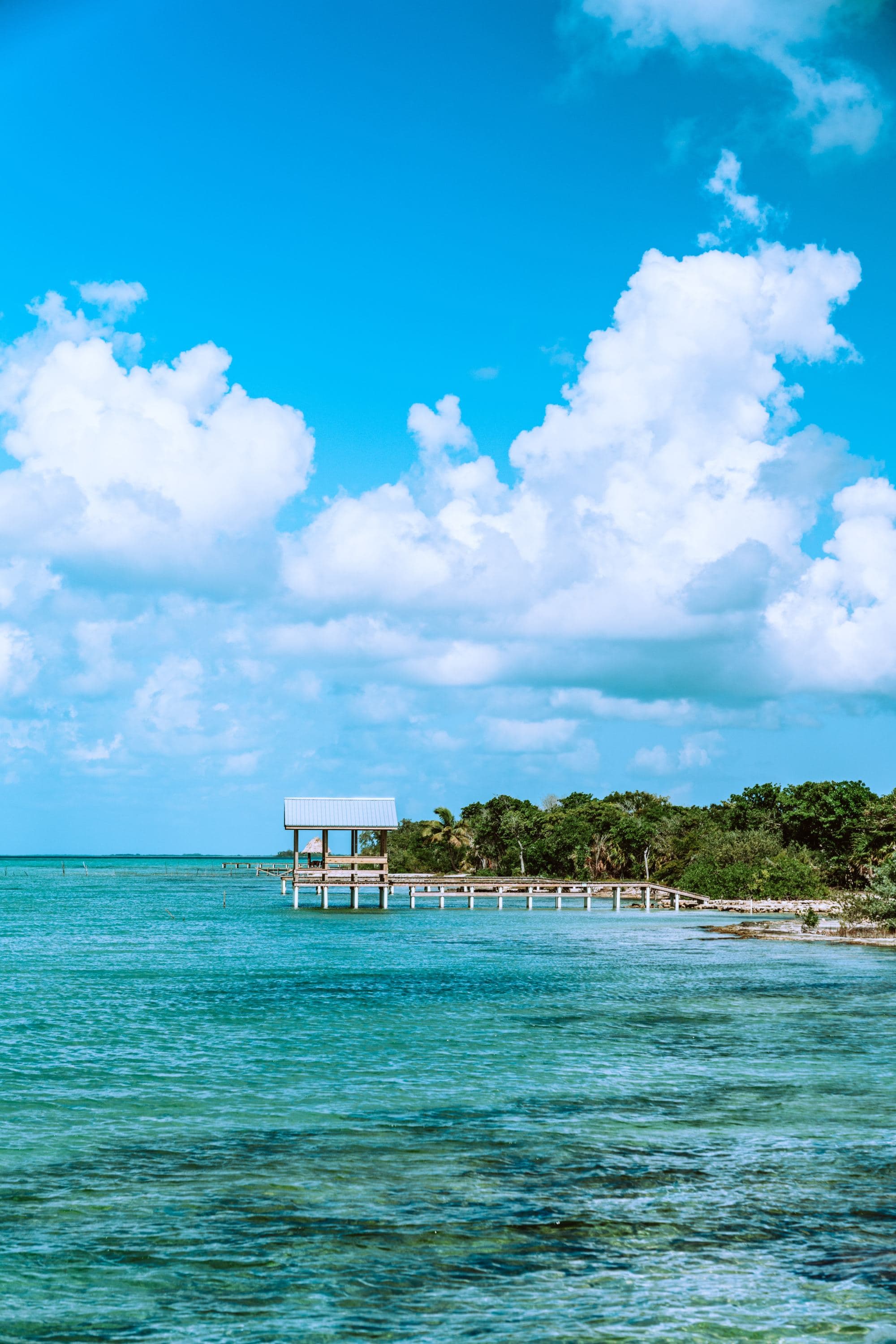 wooden pier jutting out onto a turquoise sea