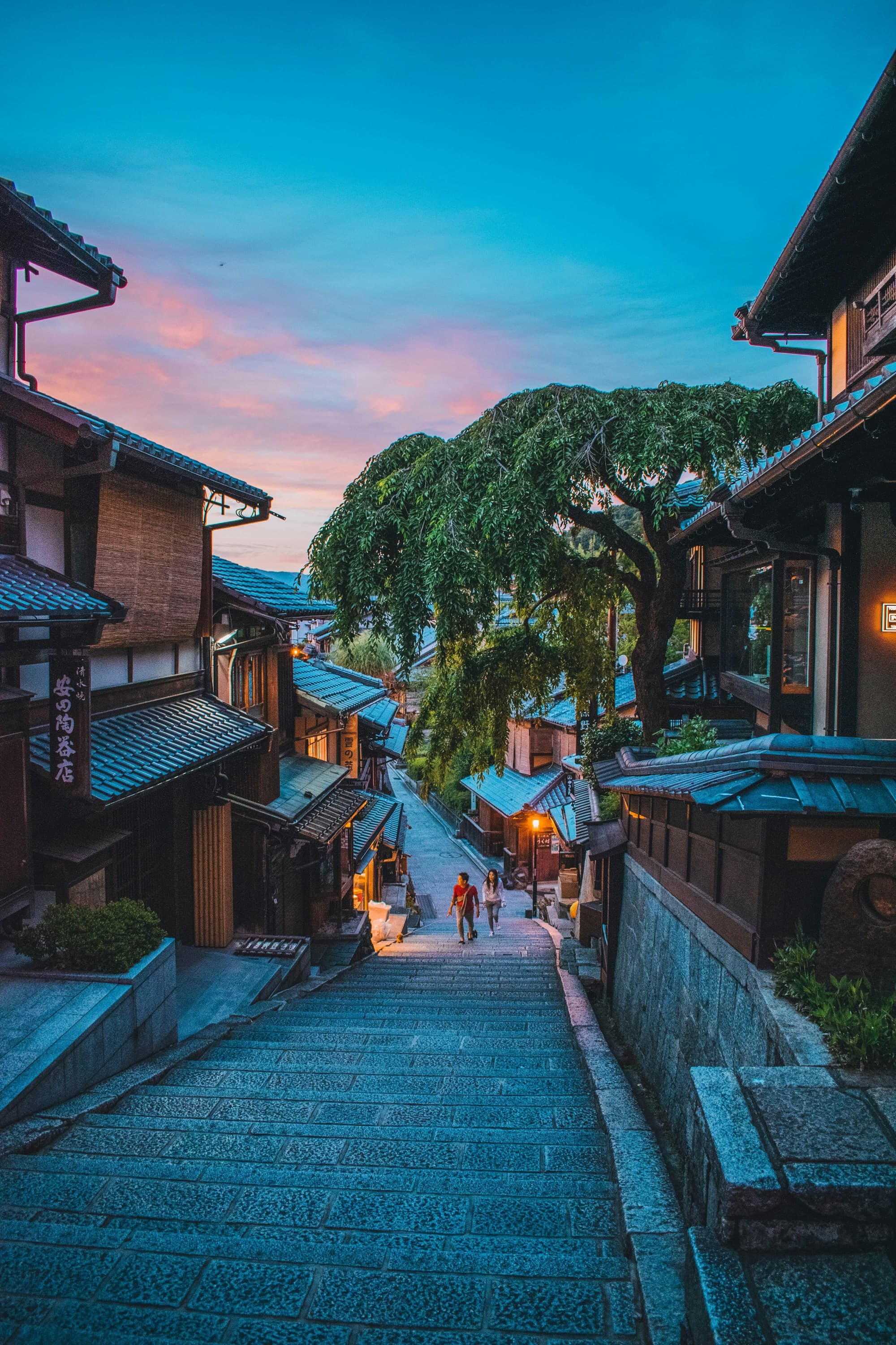 A picture of the brown wooden houses near green trees during daytime.