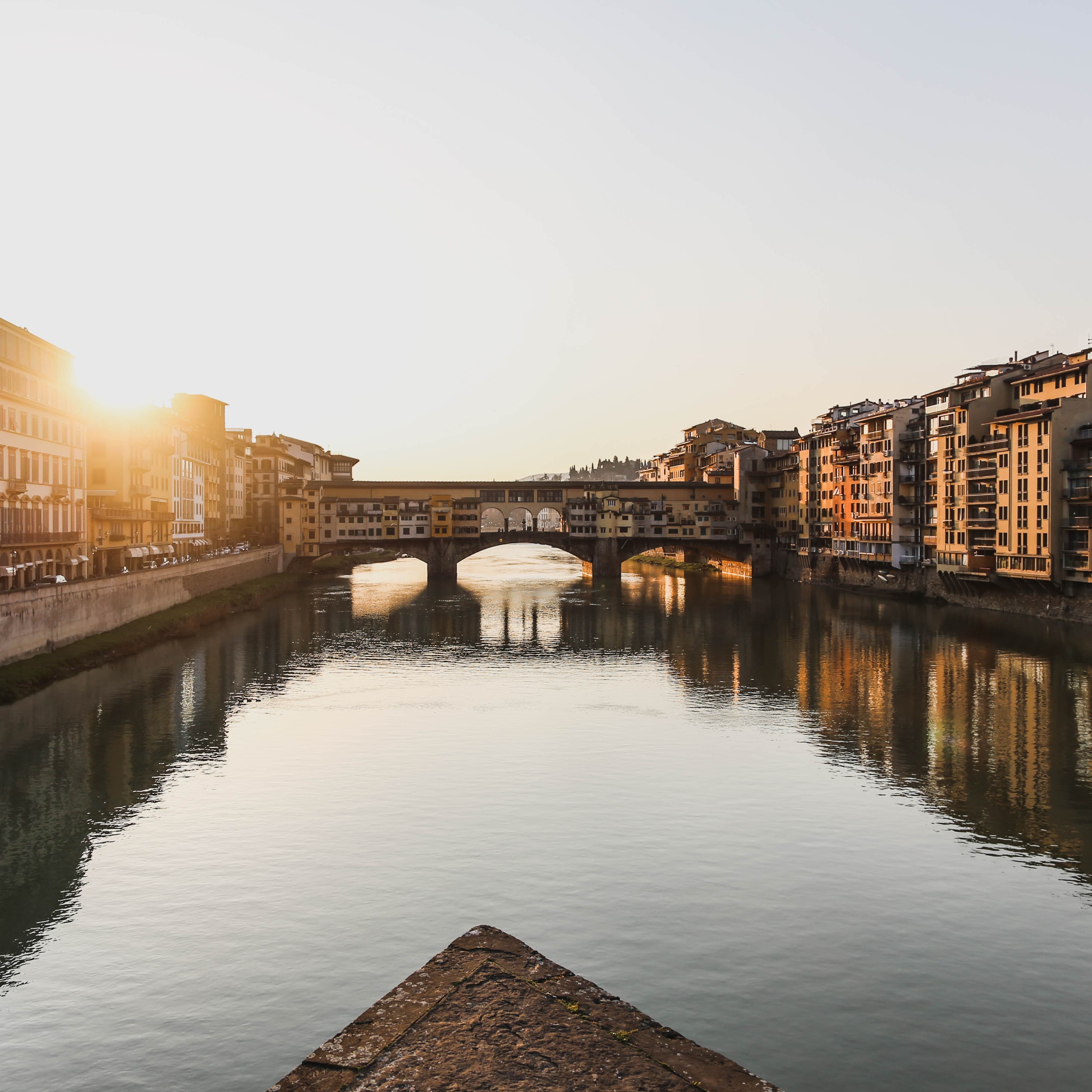 A lake flowing within the city with buildings on both side.