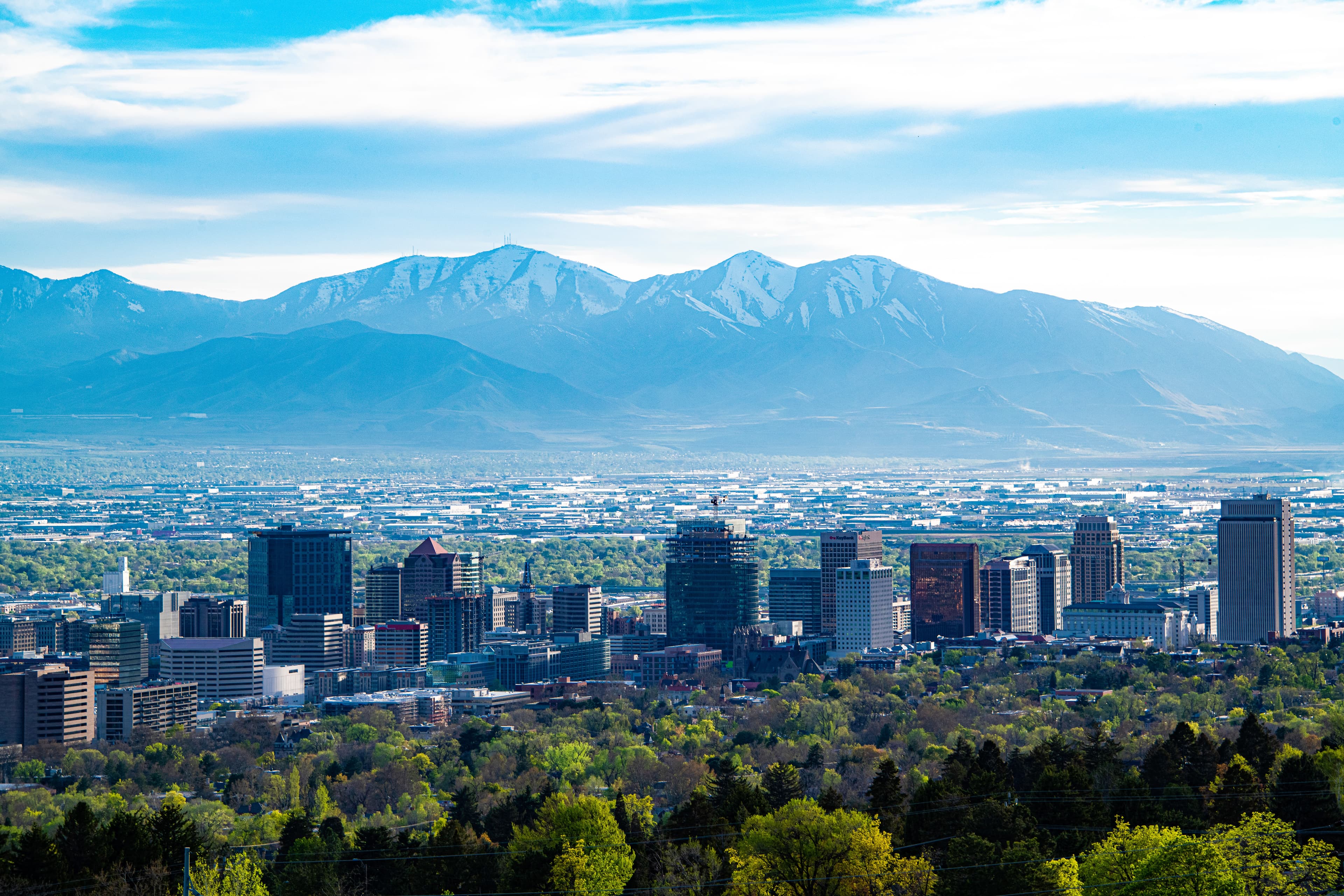 city skyline with mountains in the background during daytime