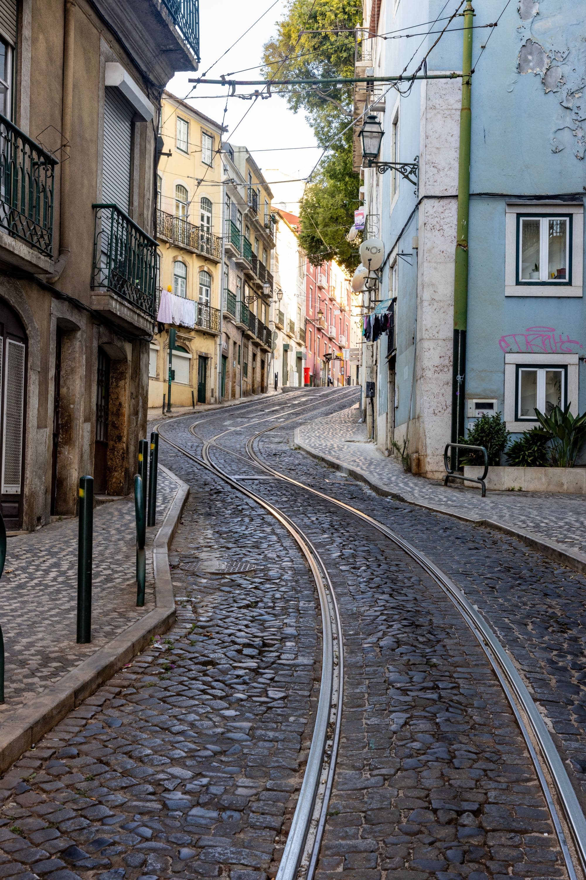 A cobblestone street with a train track running through it.