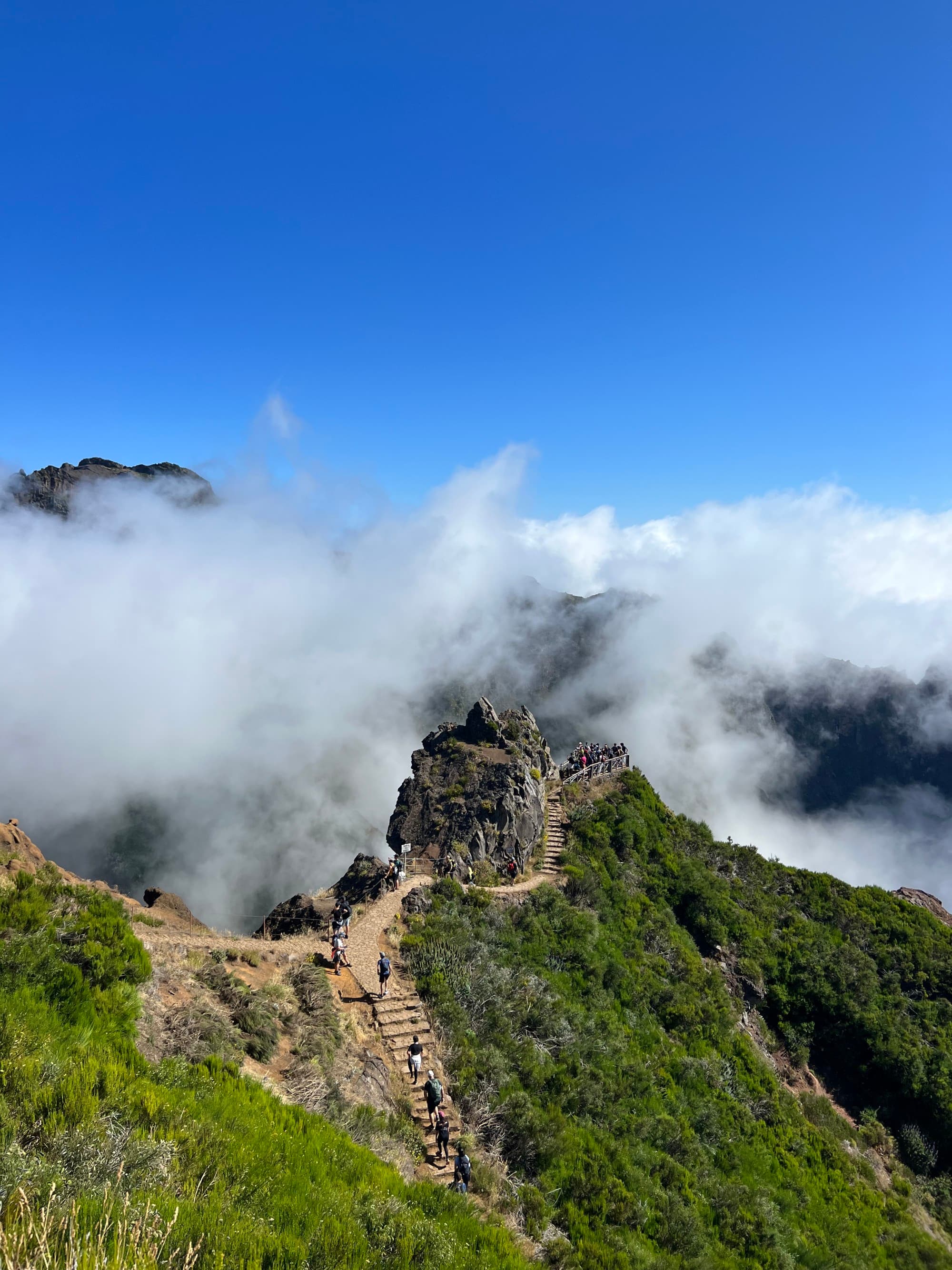 An aerial view of the mountain covered with clouds during daytime