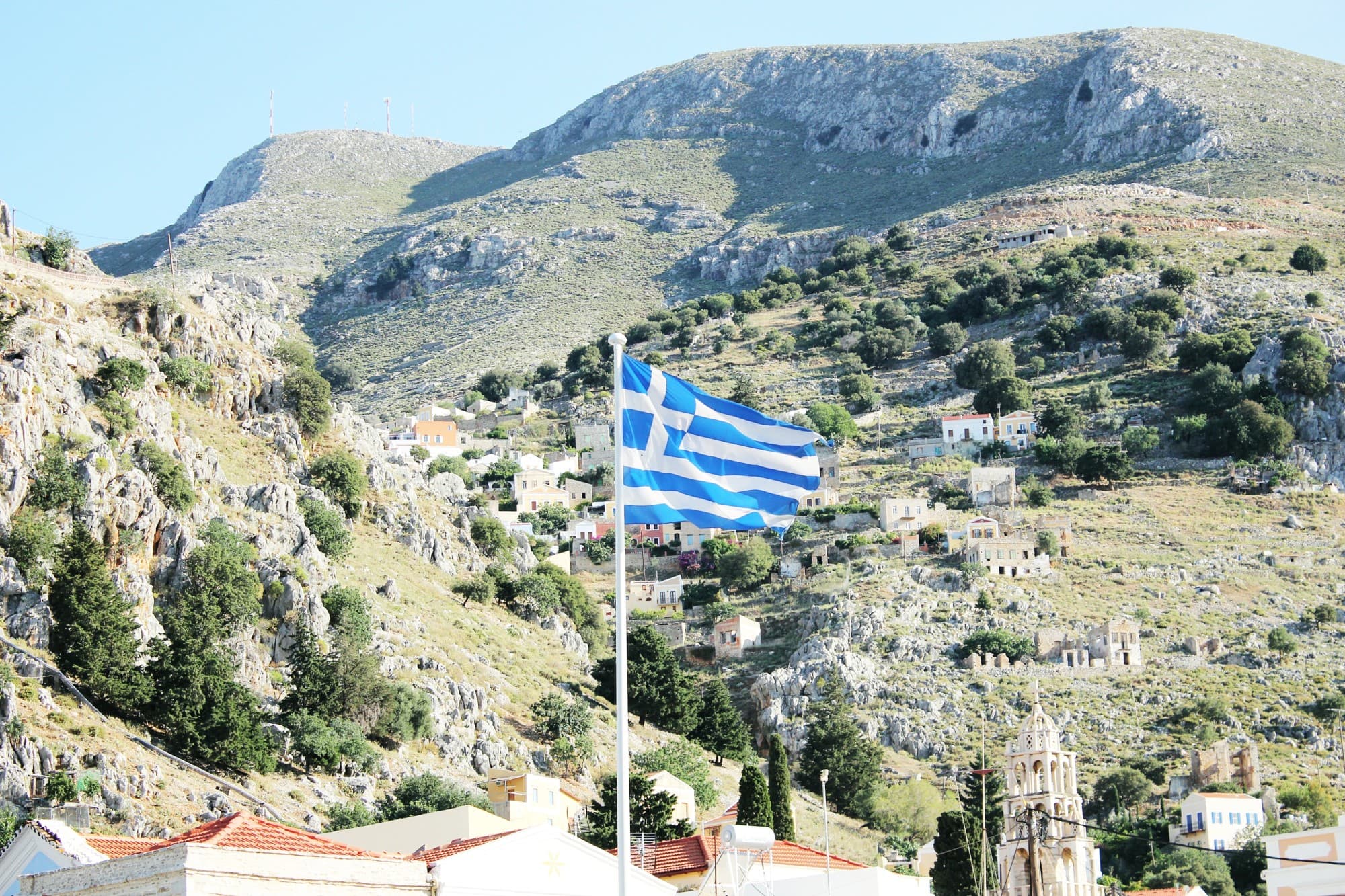 country side with Greece flag waving