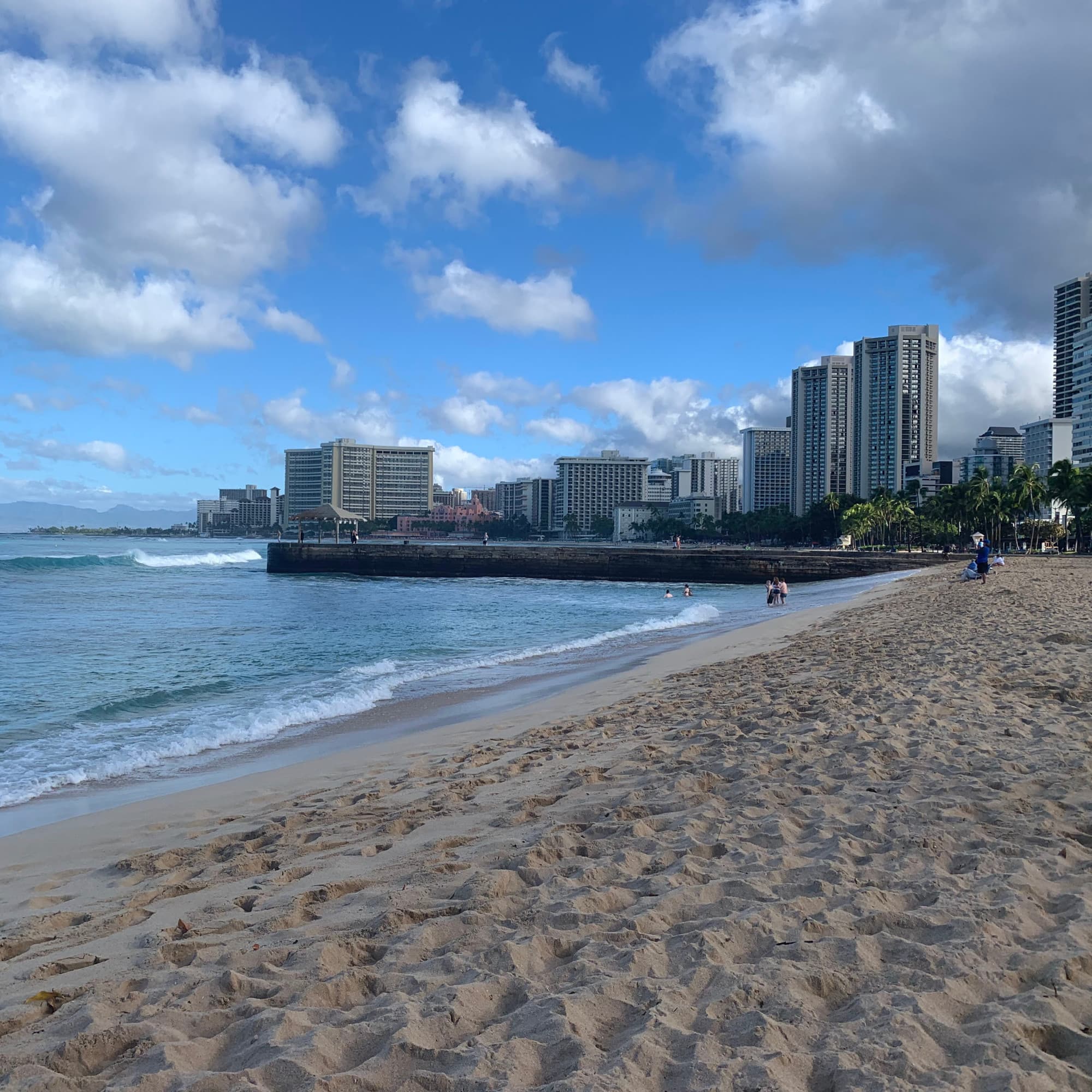 A far view of the beach near the city during daytime.