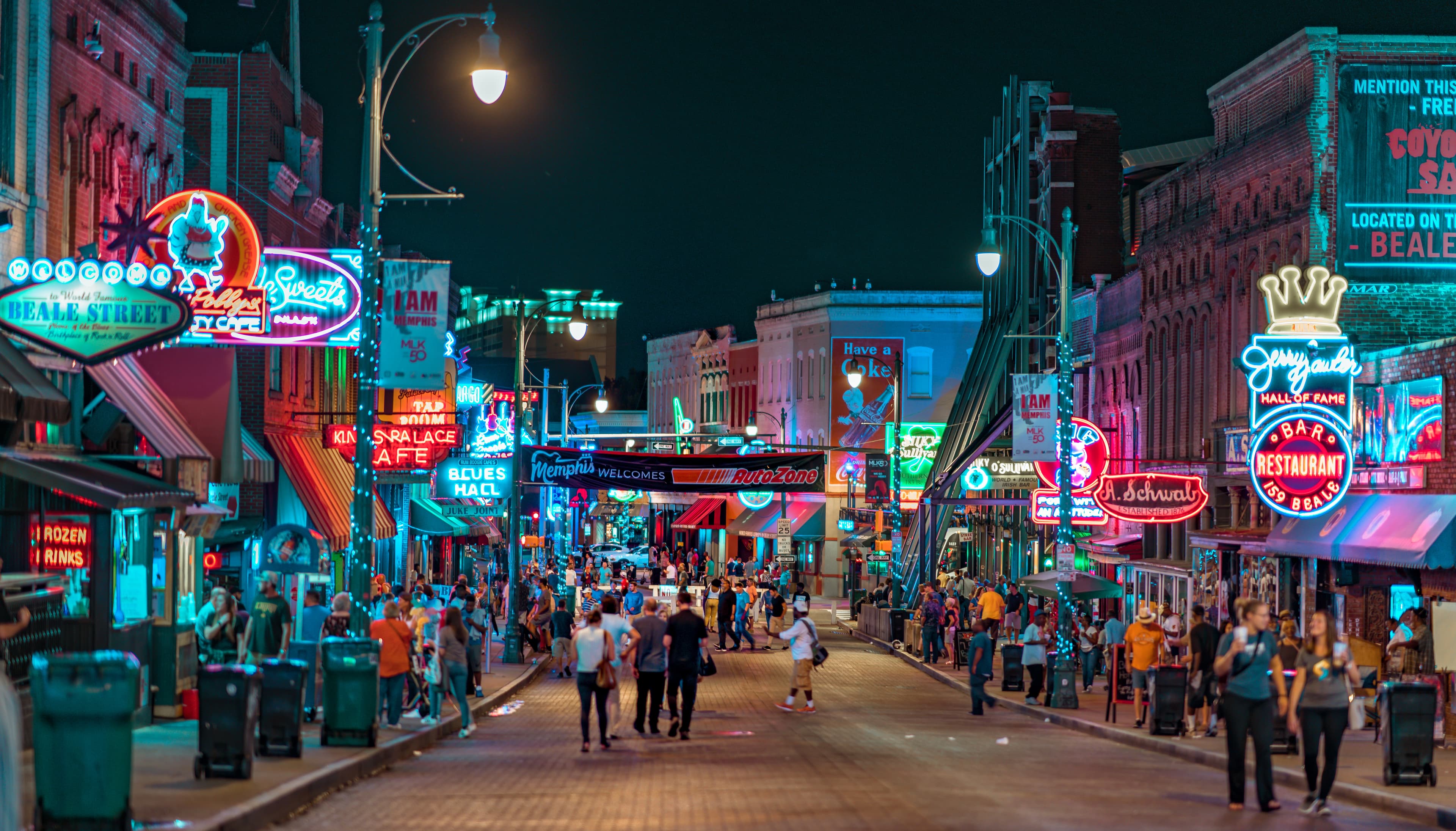 street with people and bright lights during nighttime