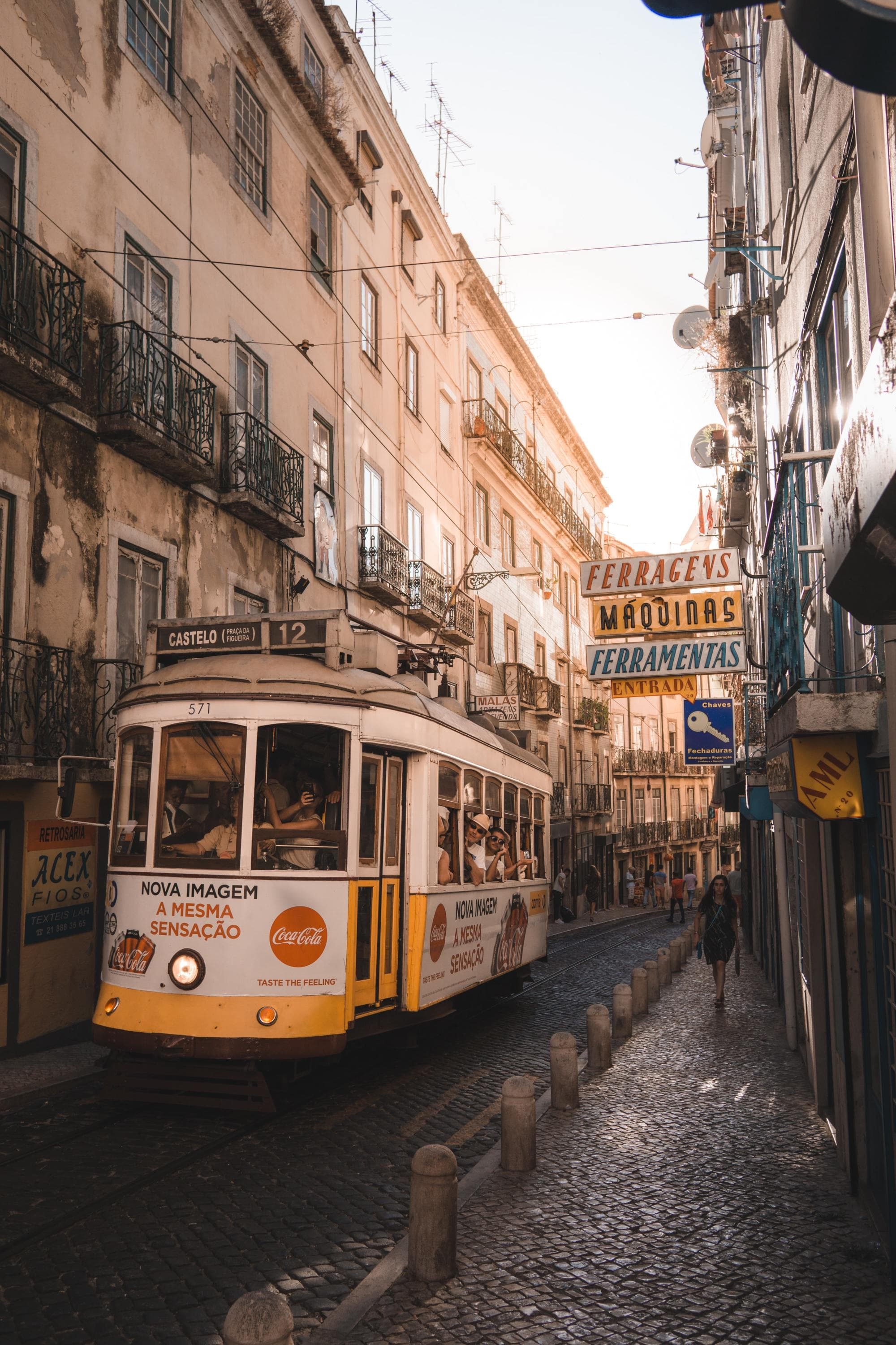 urban tram car in a narrow cobblestoned alleyway