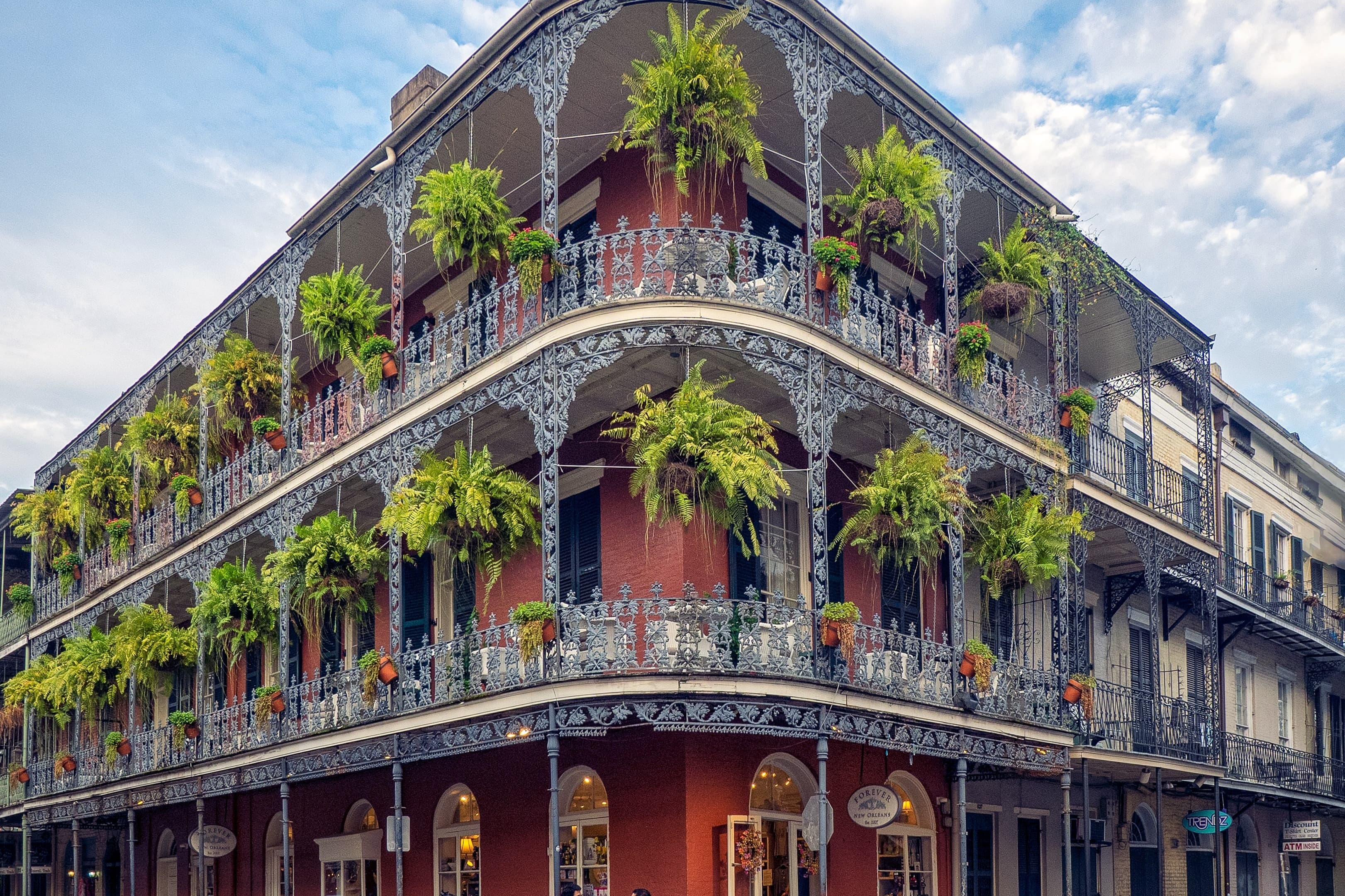A huge building having trees hanging on the balcony