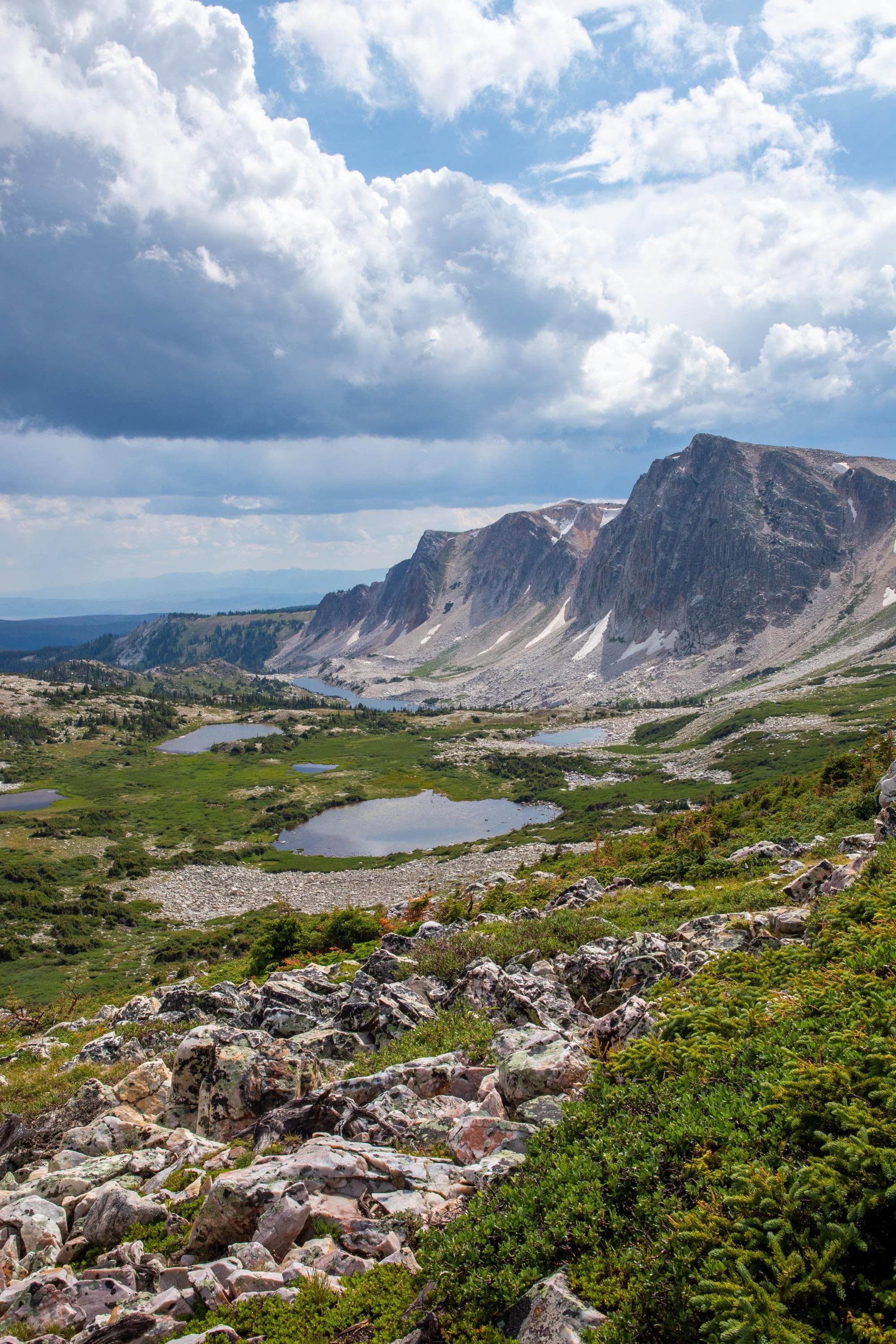 A valley with mountains and a cloudy sky.
