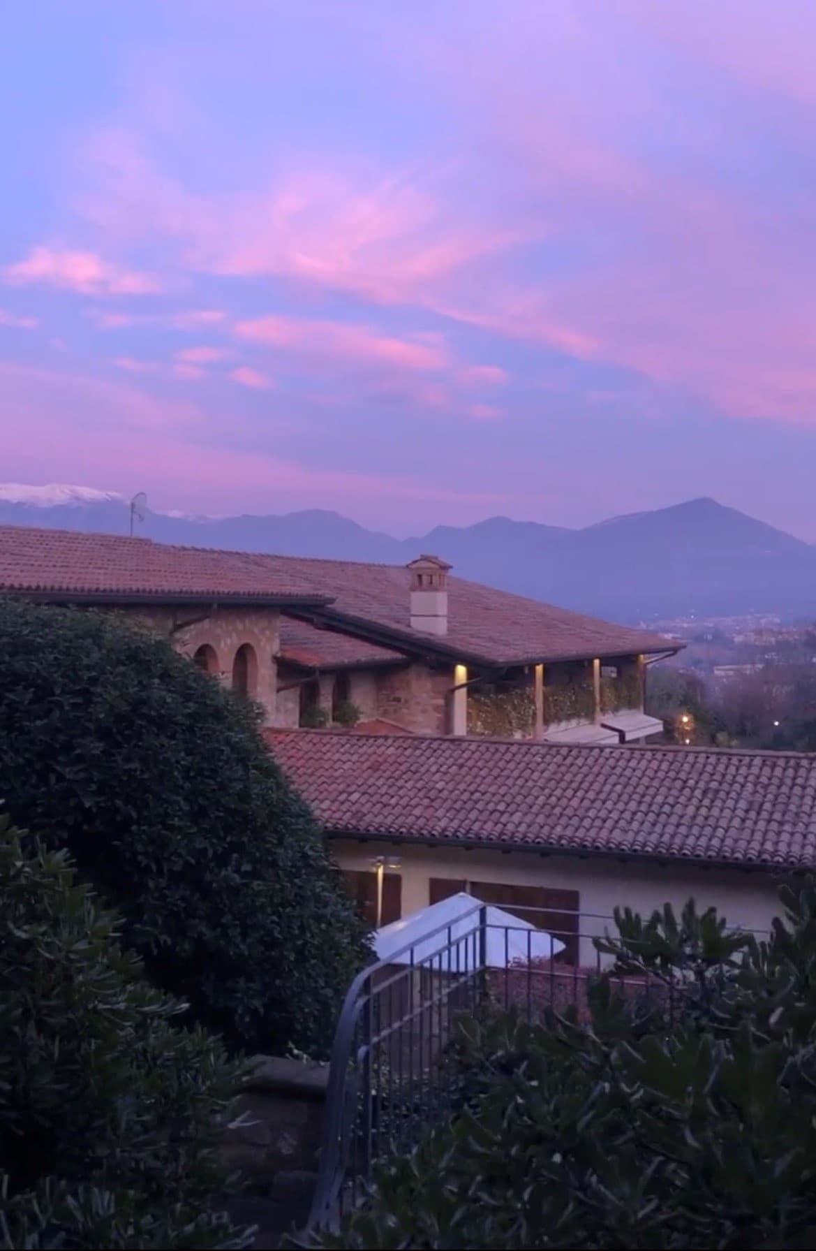 A view from the top of the mountains in Lombardy, overlooking a lake.